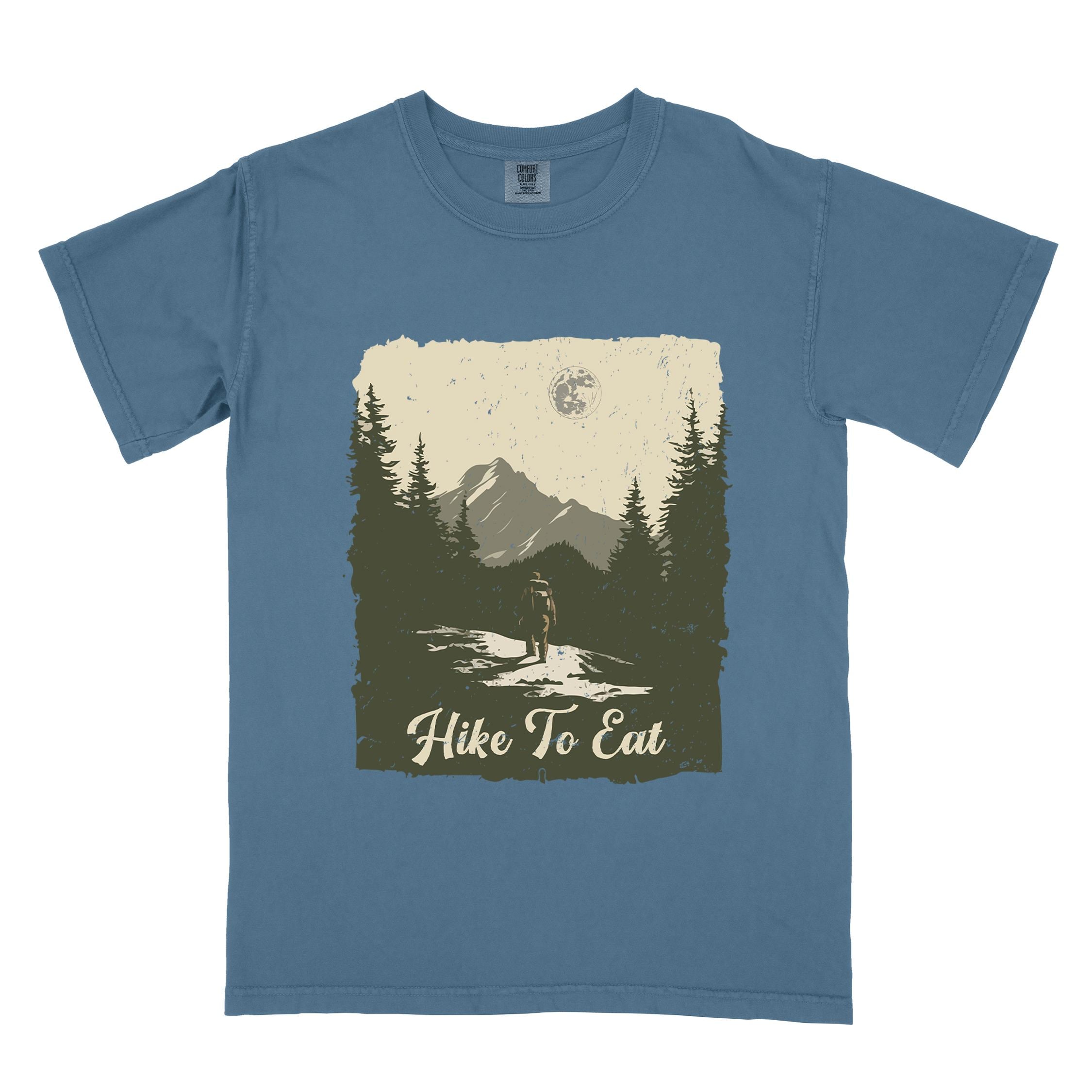 Blue jean "Hike to Eat" colored vintage tee with bold typography, illustrated landscape, and backpacker for burger enthusiasts.