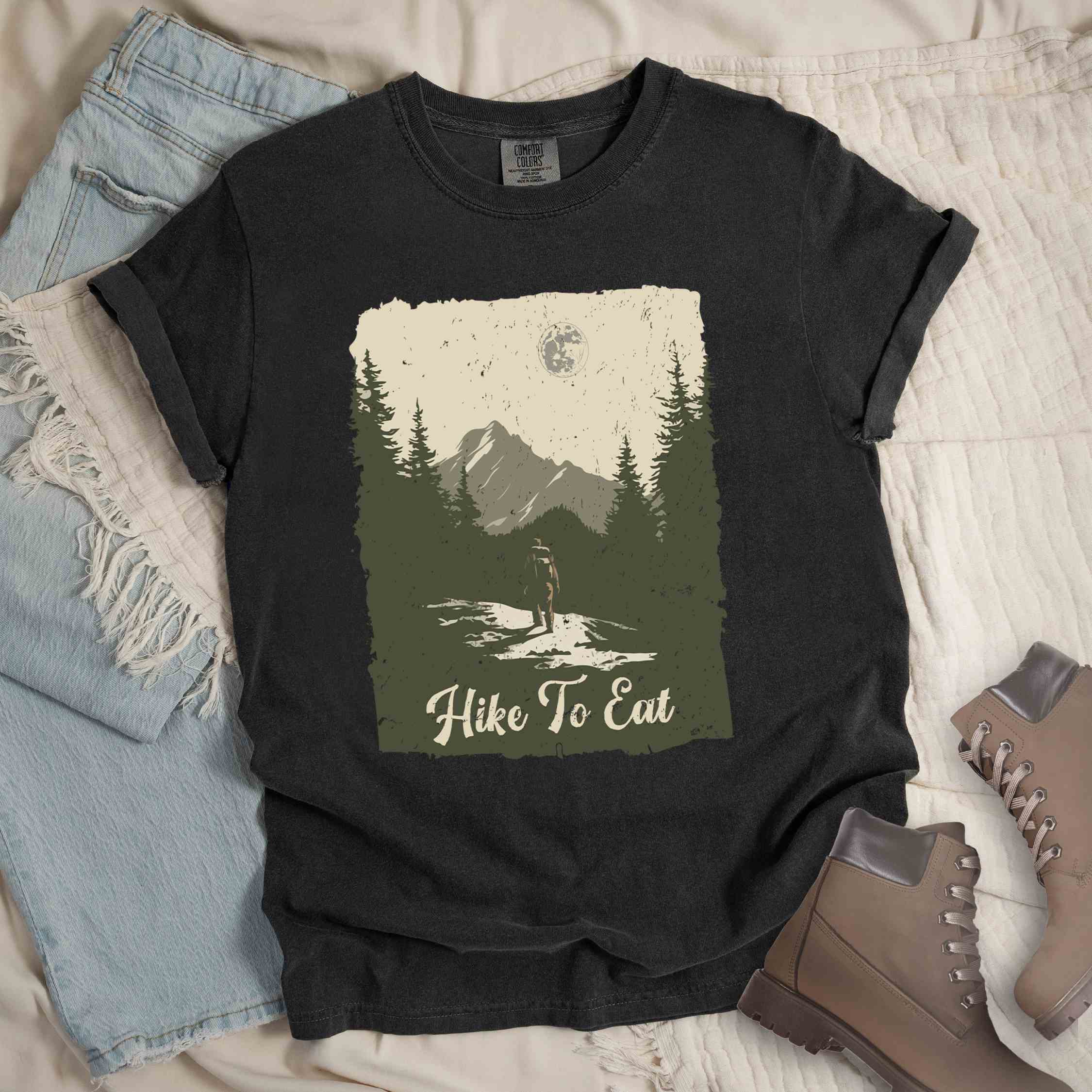 Graphite "Hike to Eat" colored vintage tee with bold typography, illustrated landscape, and backpacker for burger enthusiasts.