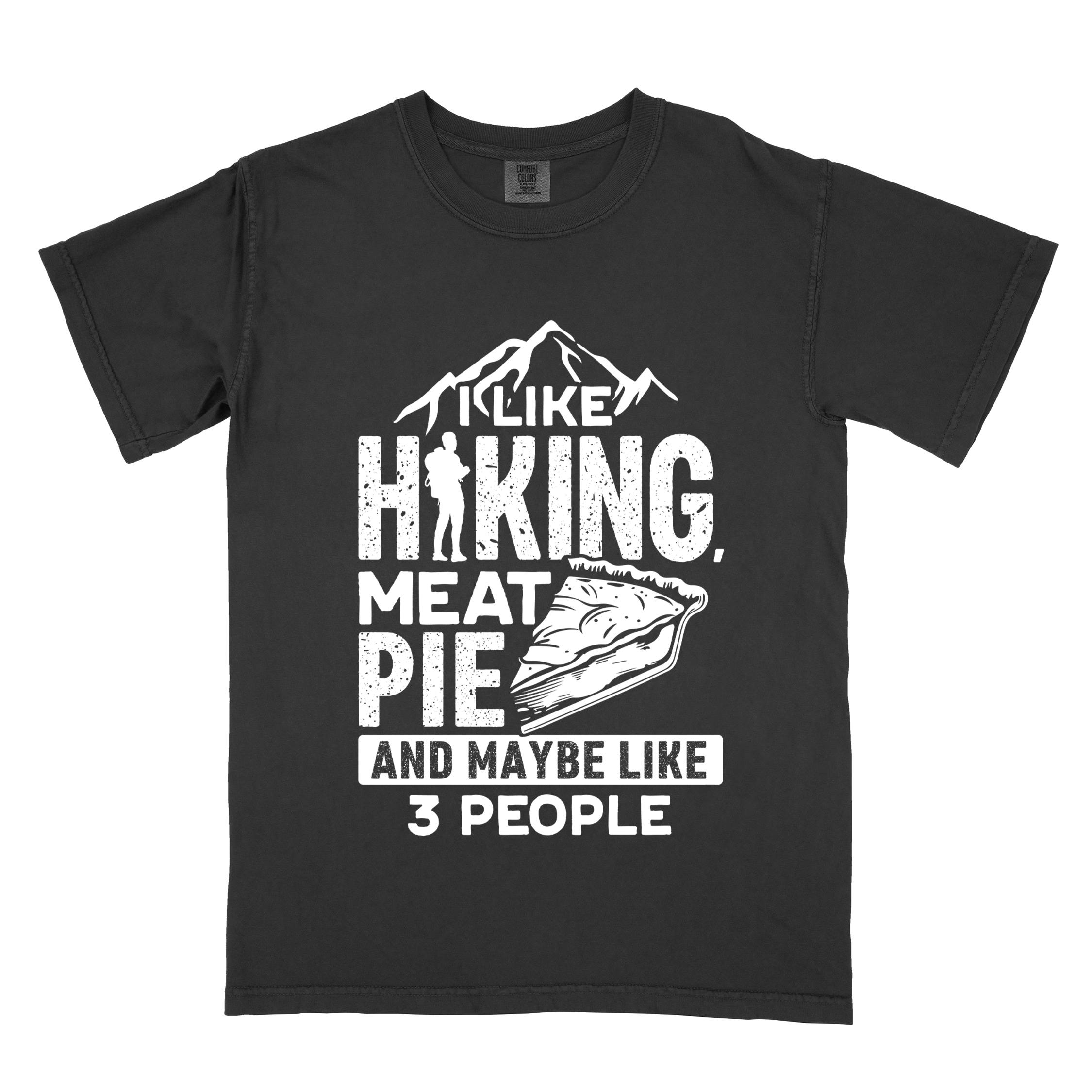Black "I like hiking, meat pie and maybe like 3 people" colored vintage tee with bold typography, mountains, birds, illustrated slice of meat pie, and backpacker for pie lovers.