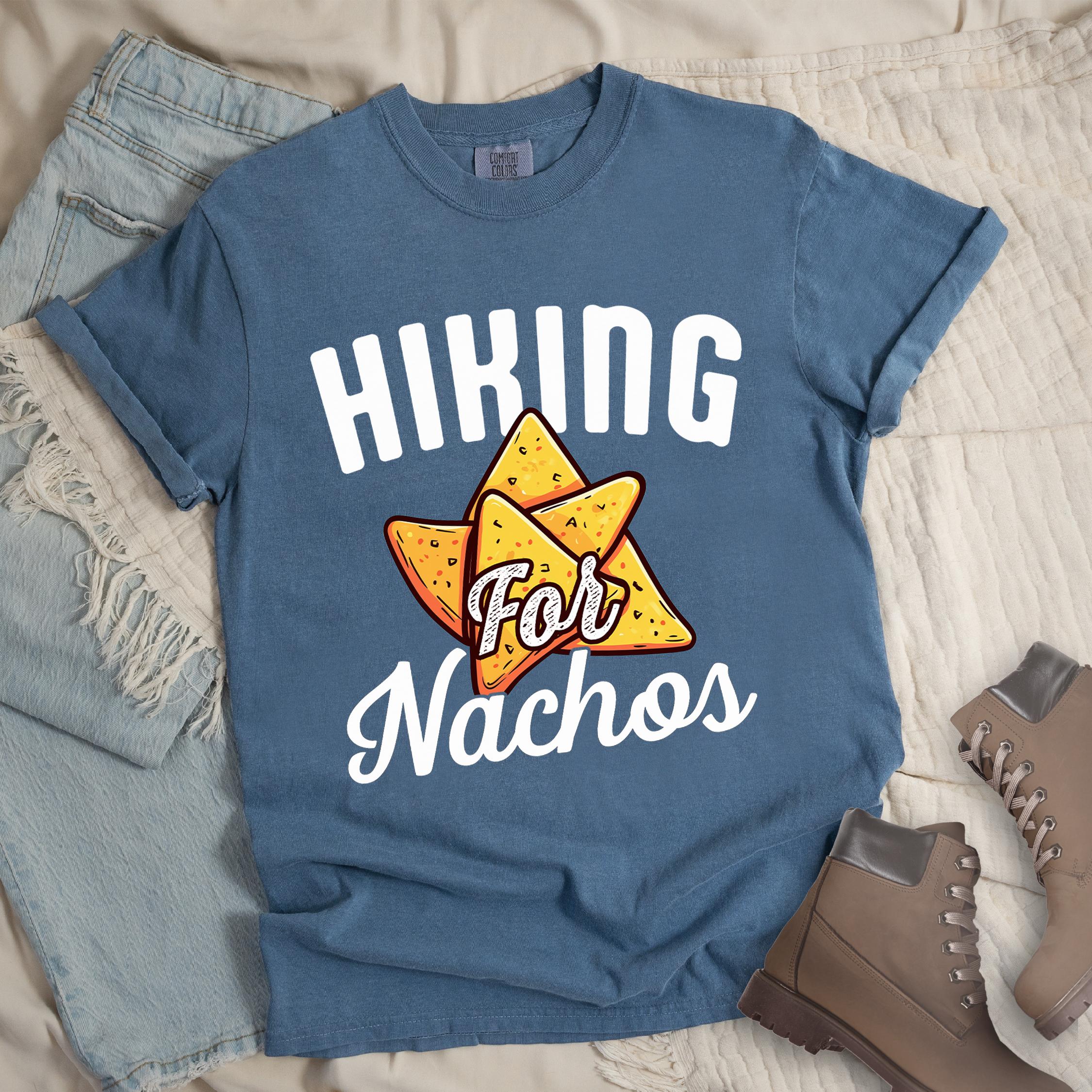 Dark blue shirt with Hiking Design featuring the phrase “Hiking for Nachos” and an illustration of golden nacho chips arranged in a triangle formation.