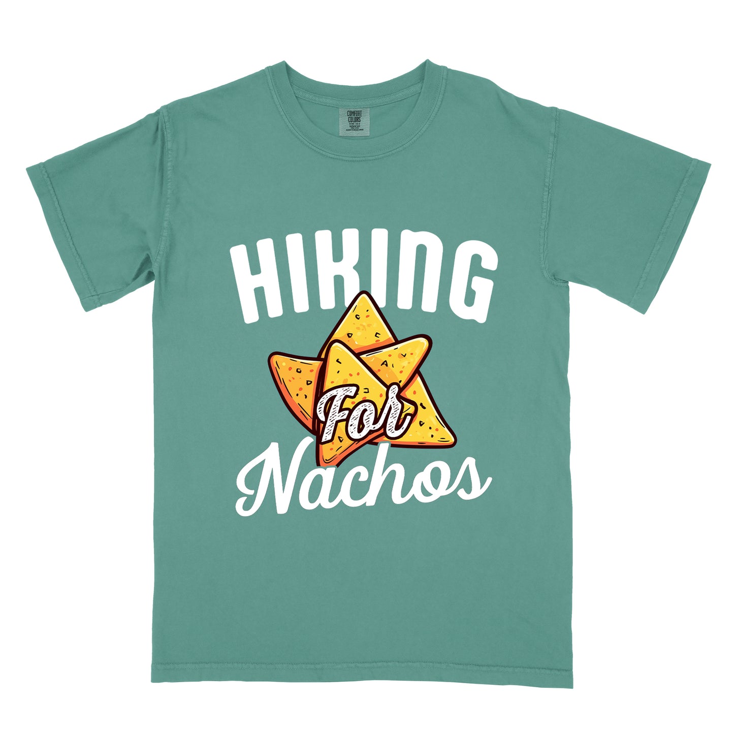 Light Green t-shirt with white text reading "HIKING For Nachos". "HIKING" appears in large white letters at the top, "For" in white script across the middle, and "Nachos" in white script at the bottom. The centerpiece of the design is an illustration of tortilla chips arranged in a star-like pattern, colored yellow-orange with flecks to represent seasonings. The design connects hiking activity with food motivation.