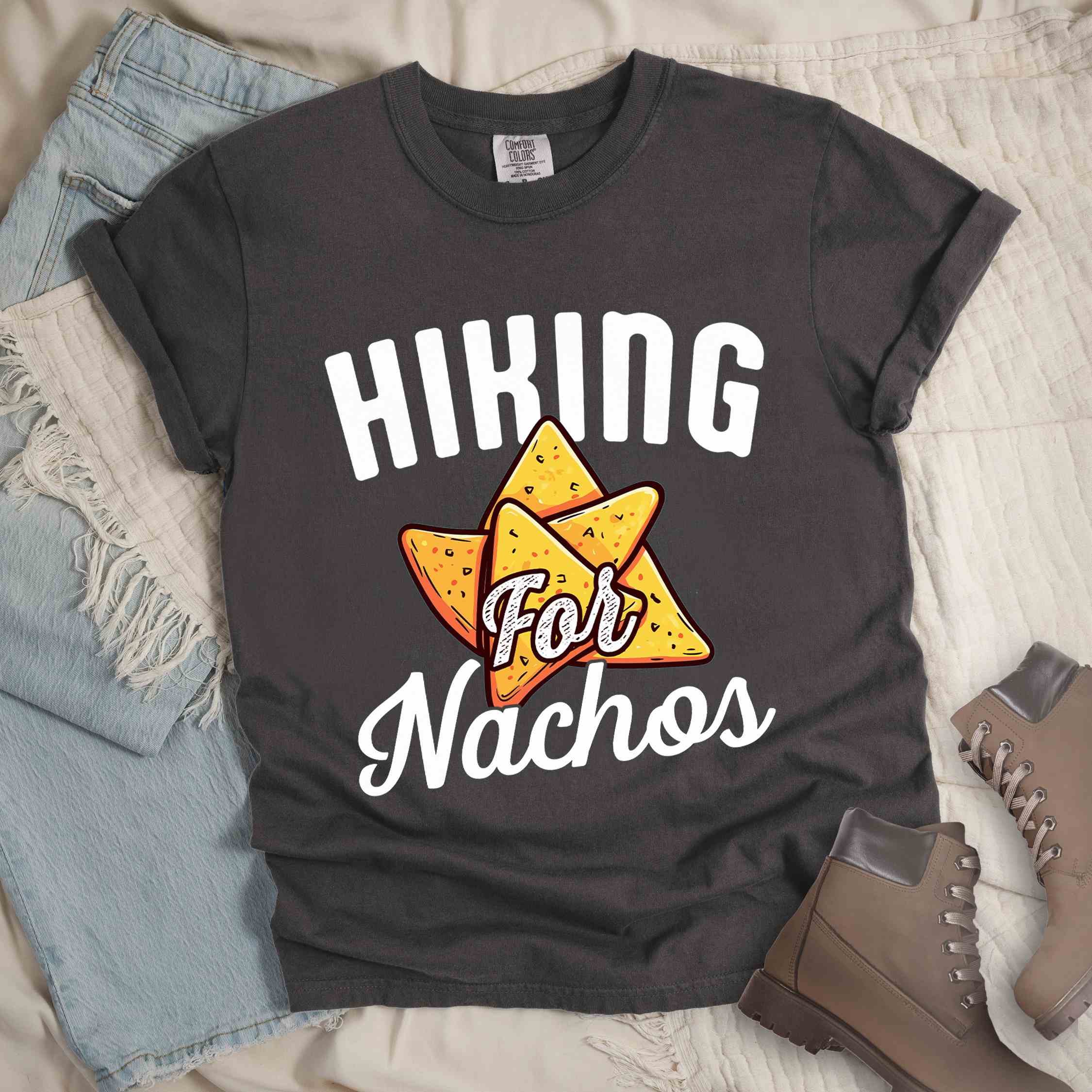 pepper "Hiking for Nachos" colored vintage tee with bold typography, illustrated crispy nachos chips, and backpacker craving for chips.