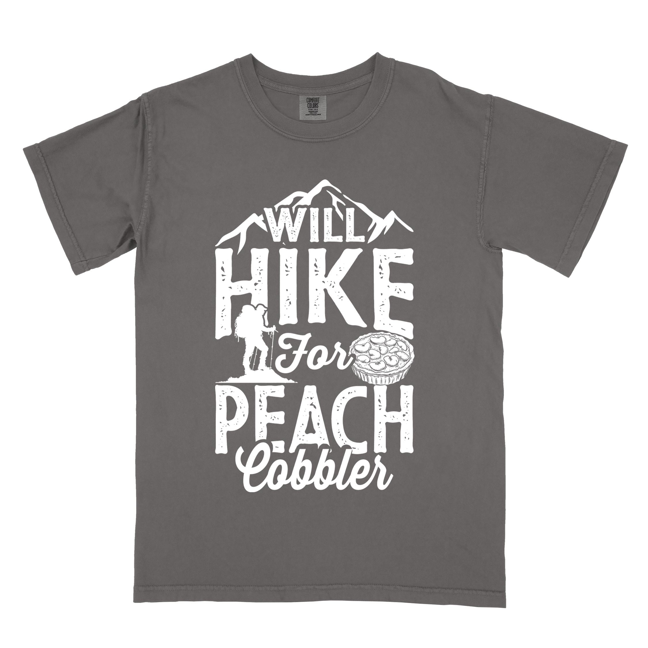 Pepper "Will hike for peach cobbler" colored vintage tee with bold typography, mountain, birds, illustrated peach cobbler, and backpacker looking for sweet treats.