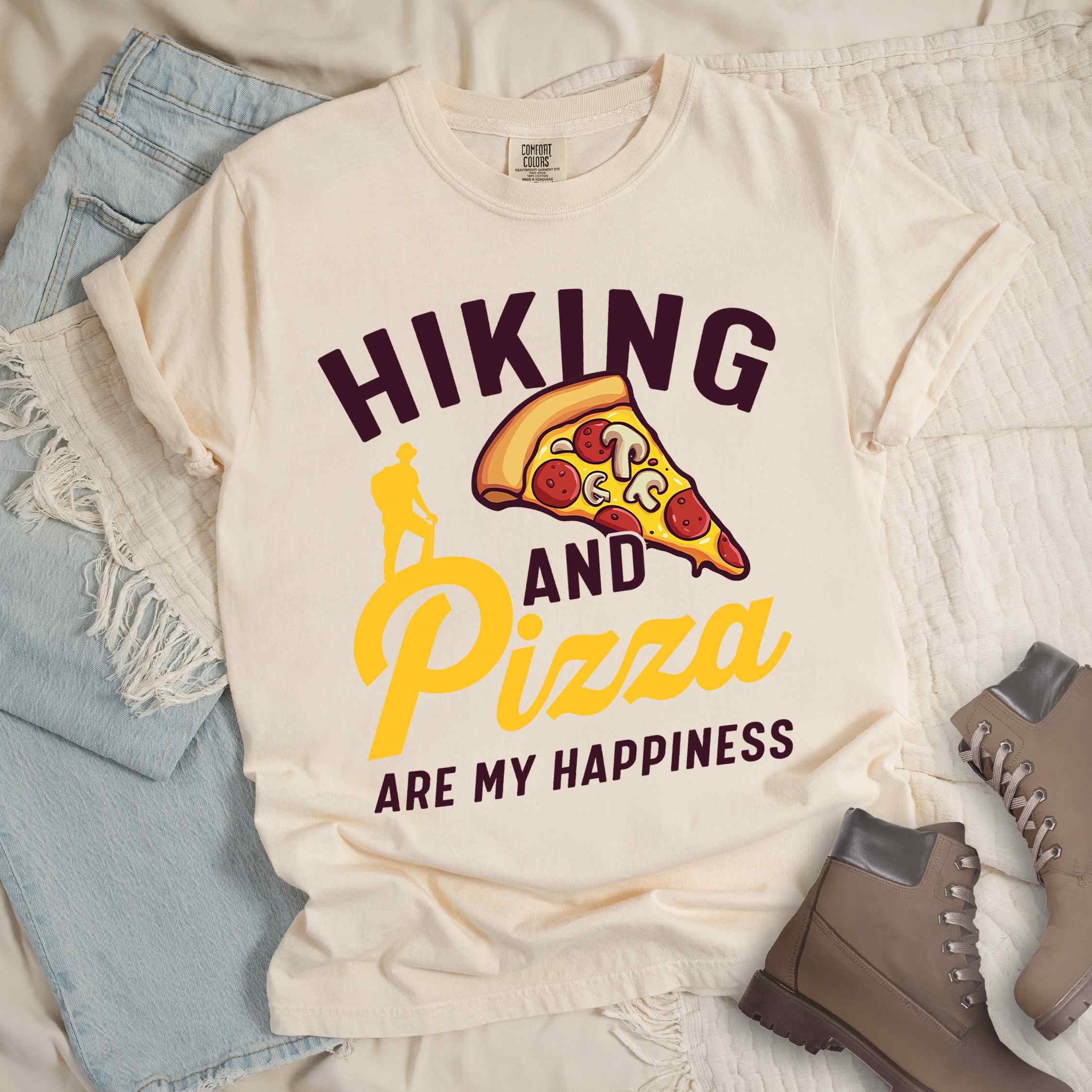 Ivory "Hiking and Pizza are my happiness" colored vintage tee with bold typography, birds, mountains, illustrated pizza slice, and backpacker for pizza lovers.