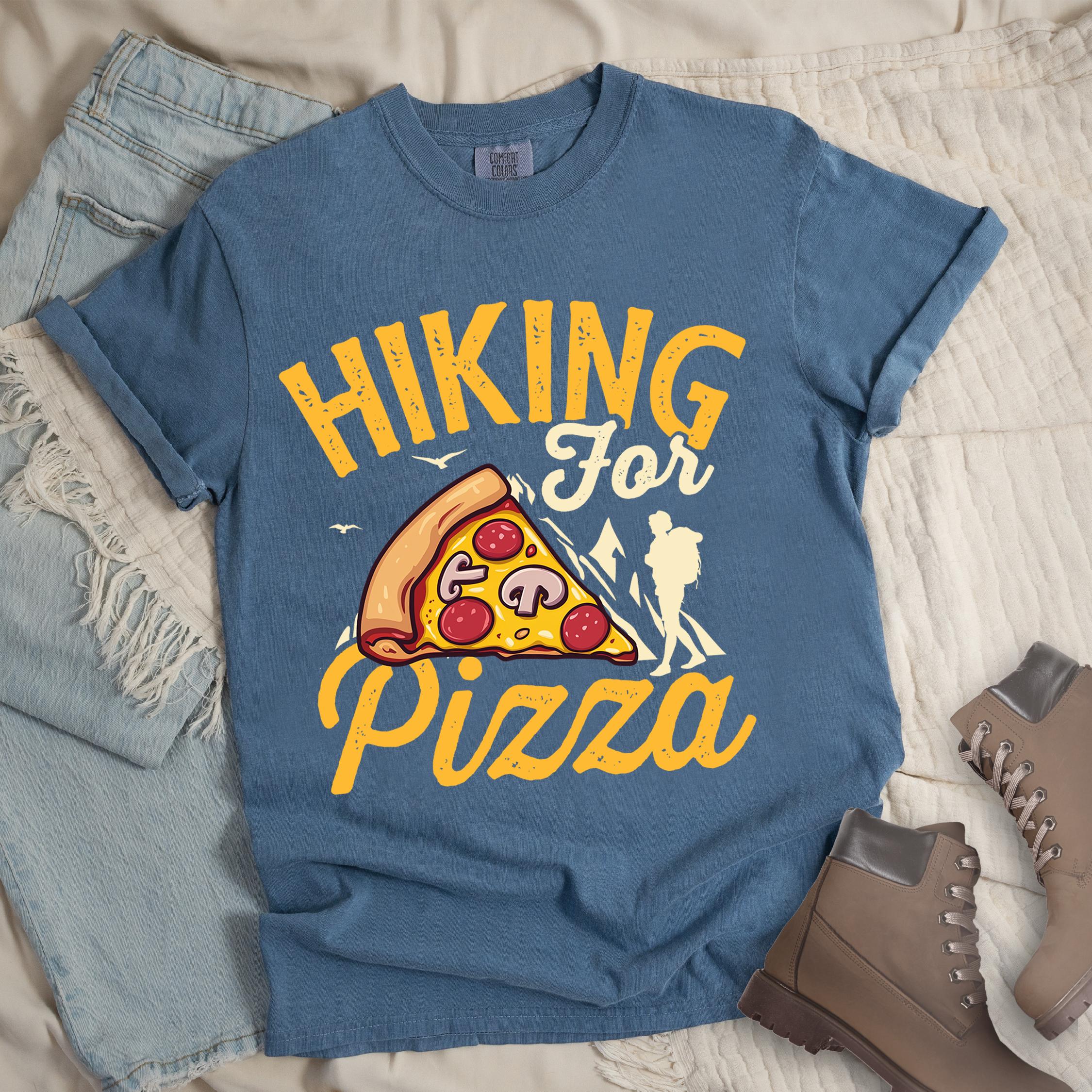 Dark blue shirt with Hiking Design featuring the phrase “Hiking for Pizza” and an illustration of a cheesy pepperoni pizza slice, mountain outline, and hiker silhouette.