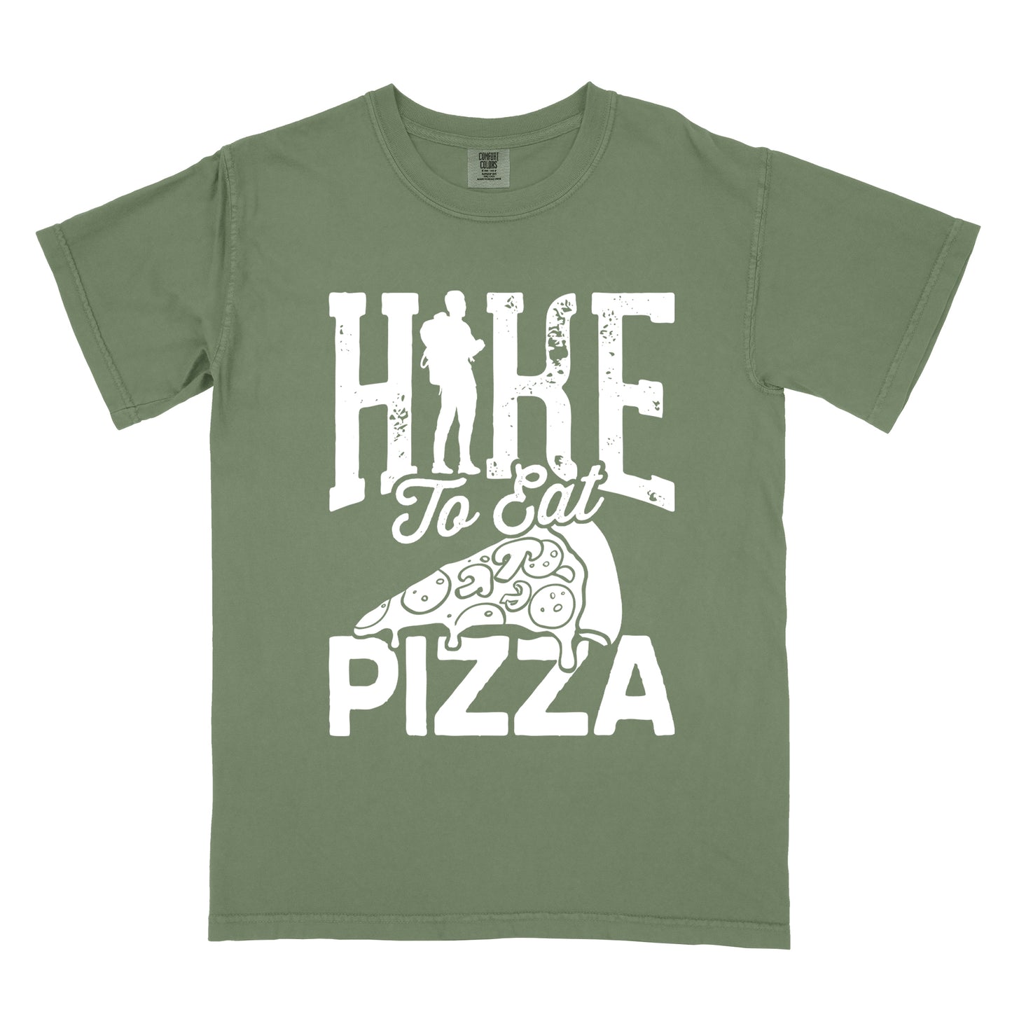 Moss (Dark Green) t-shirt with white distressed text reading "HIKE To Eat PIZZA". "HIKE" appears in large block letters at the top with a silhouette of a hiker with backpack integrated into the "I", "To Eat" in script in the middle, and "PIZZA" in large block letters at the bottom. Features a simple line drawing of a pizza slice with toppings between the phrases. The design humorously connects hiking activity with pizza as a reward.