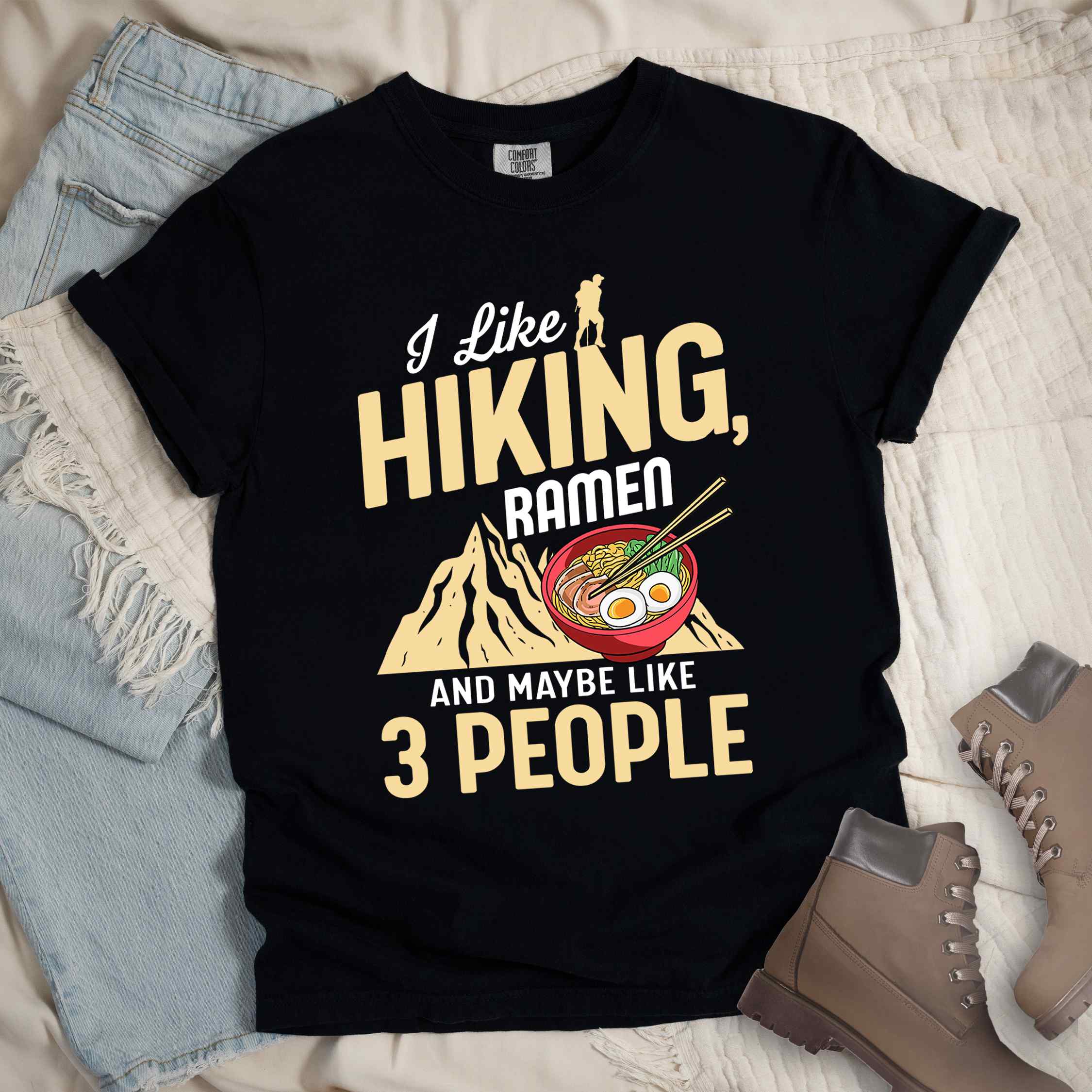 Black “Ramen is my Hiking motivation” colored vintage tee with bold text, mountain, Illustration of hot ramen. Perfect tee for a foodie craving for a bowl of ramen,