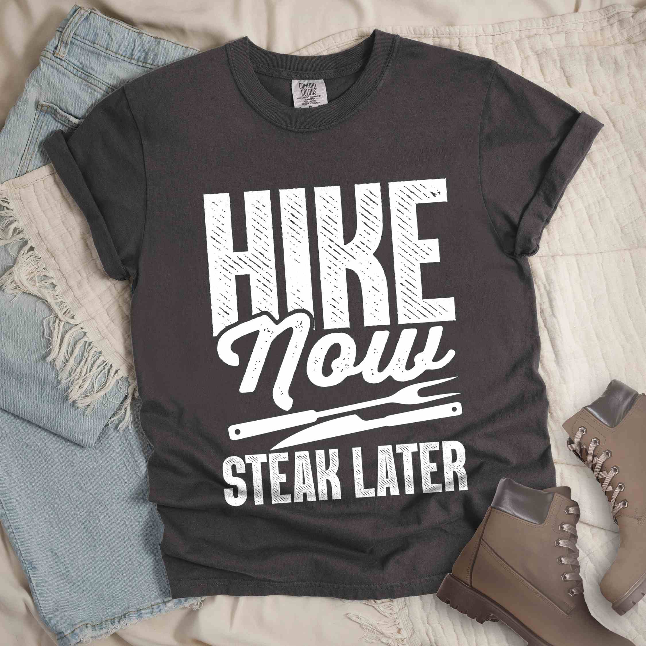 Pepper "Hike now steak later" colored vintage tee with bold typography, illustrated steak utensils, and backpacker for steak lovers.