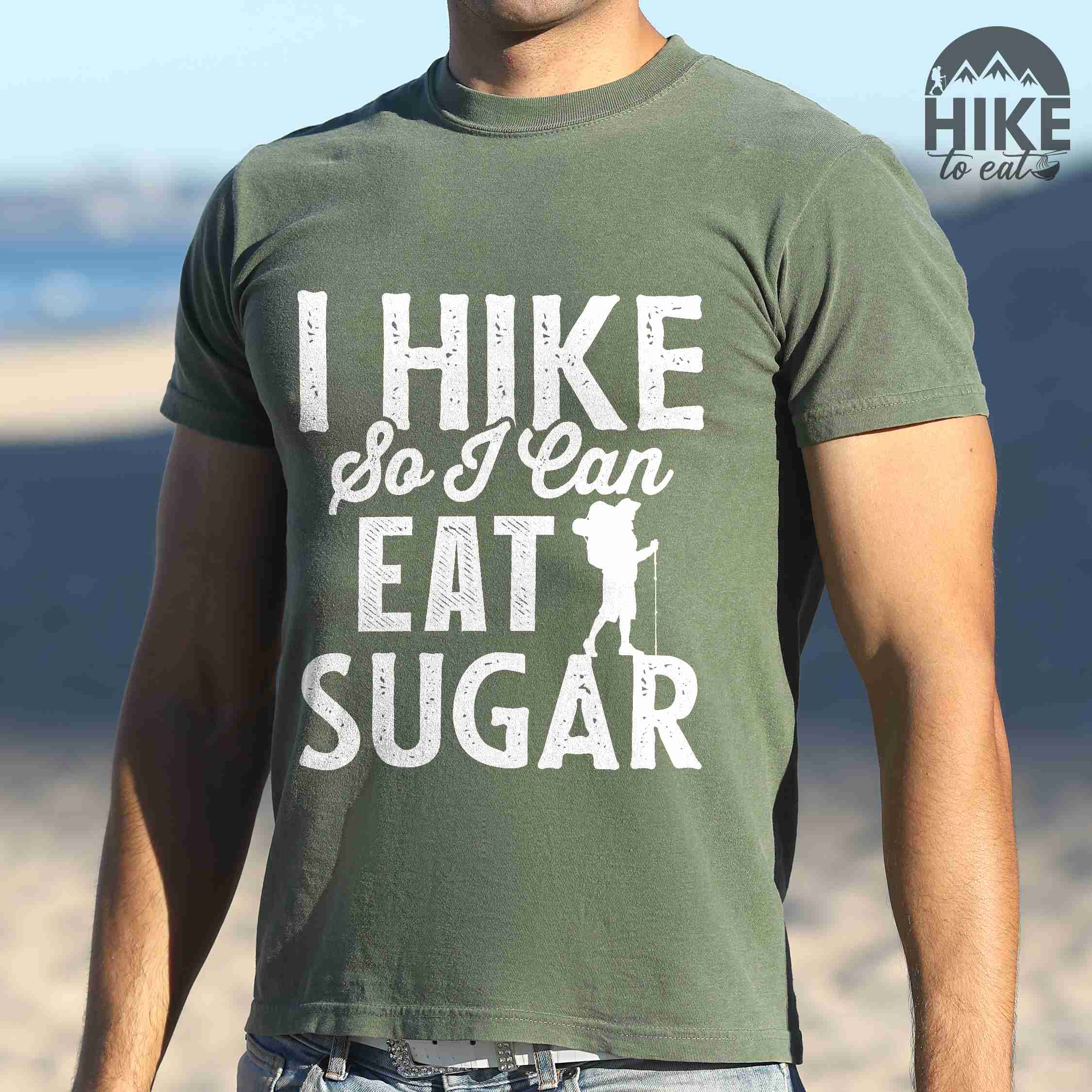 Man wearing moss "I hike so I can eat sugar" colored vintage tee with bold typography, and backpacker with a sweet tooth.