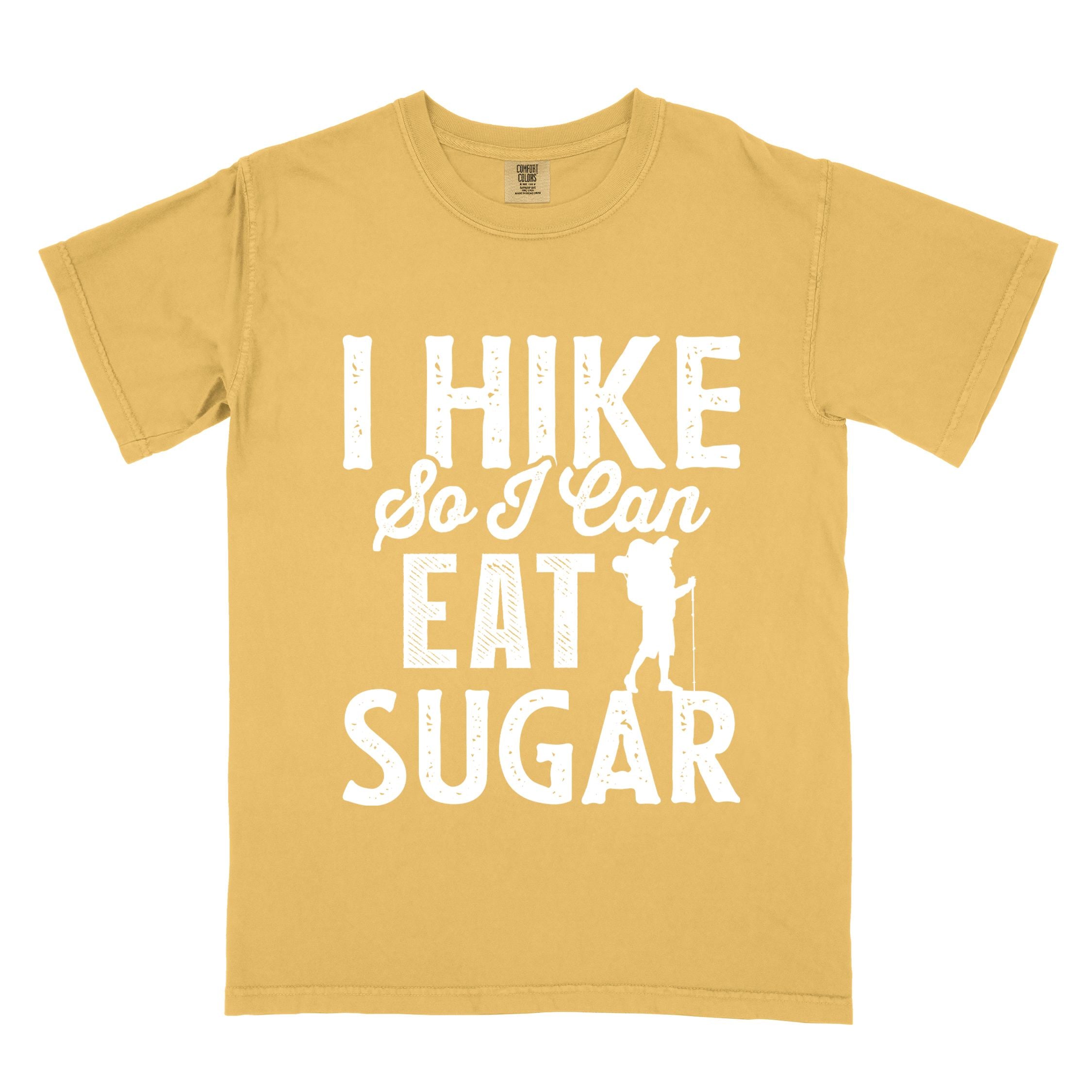 Mustard "I hike so I can eat sugar" colored vintage tee with bold typography, and backpacker with a sweet tooth.