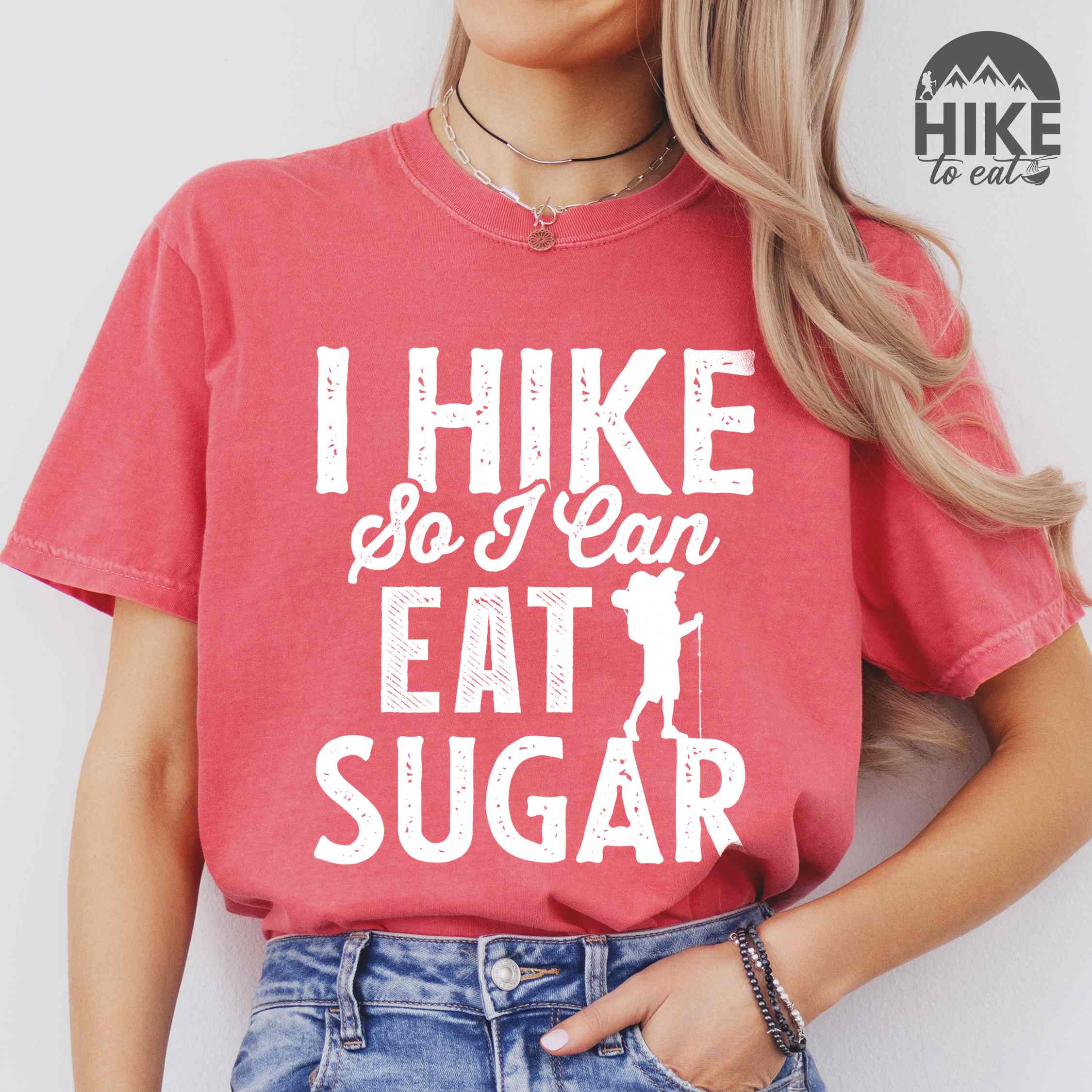 woman wearing watermelon "I hike so I can eat sugar" colored vintage tee with bold typography, and backpacker with a sweet tooth.