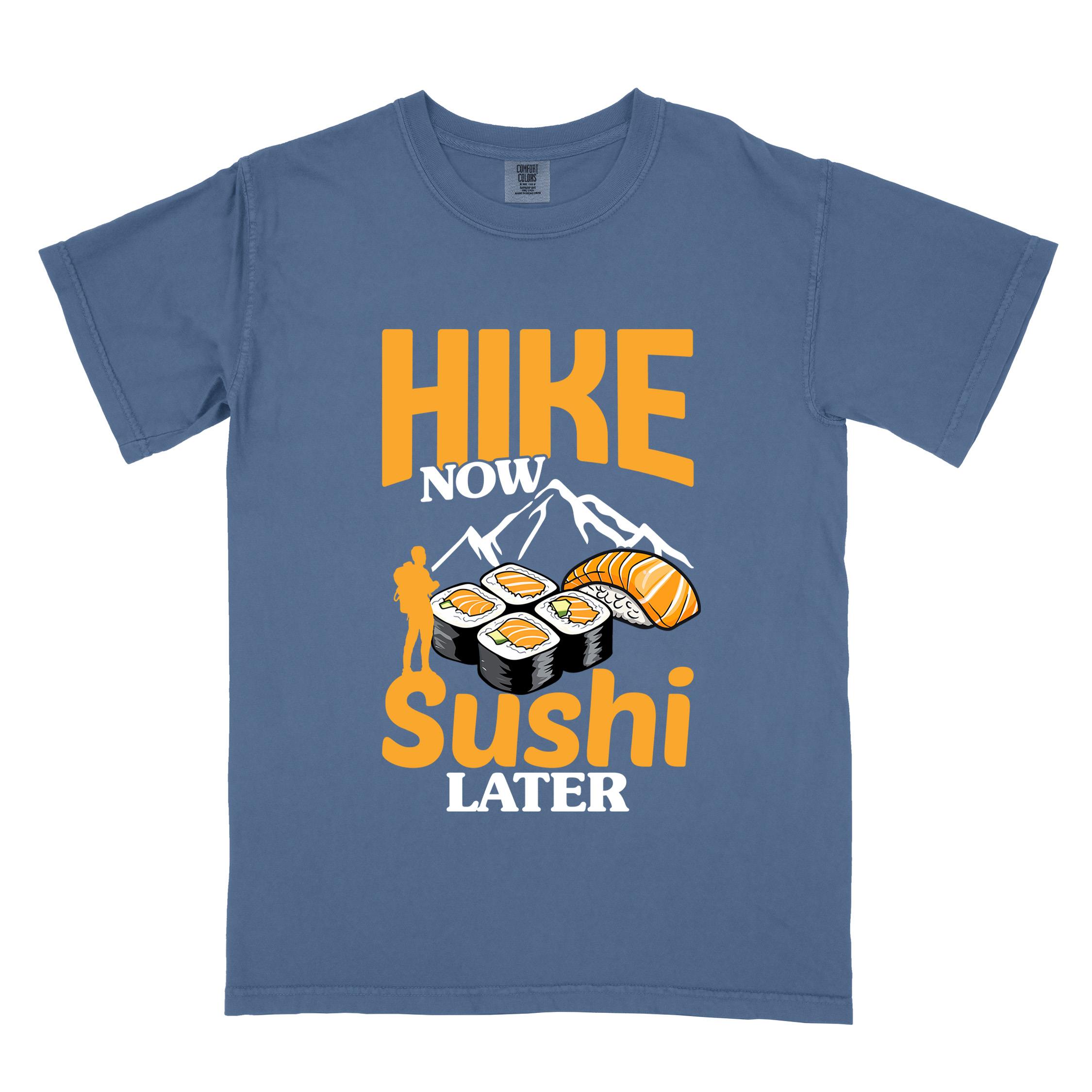 Blue jean "Hike now sushi later" colored vintage tee with bold typography, birds, mountains, illustrated sushi platter, and backpacker for sushi lovers.