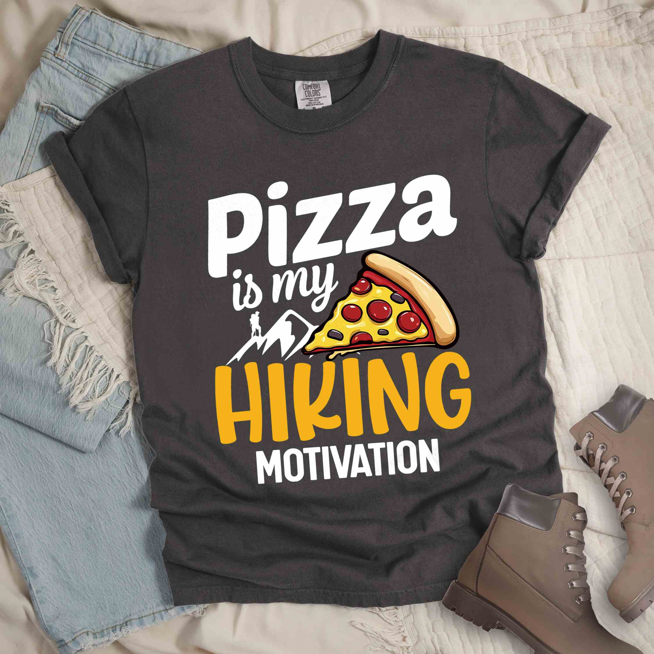 Pepper "Pizza is my hiking motivation" colored vintage tee with bold typography, birds, mountains, illustrated pizza slice, and backpacker for pizza lovers.