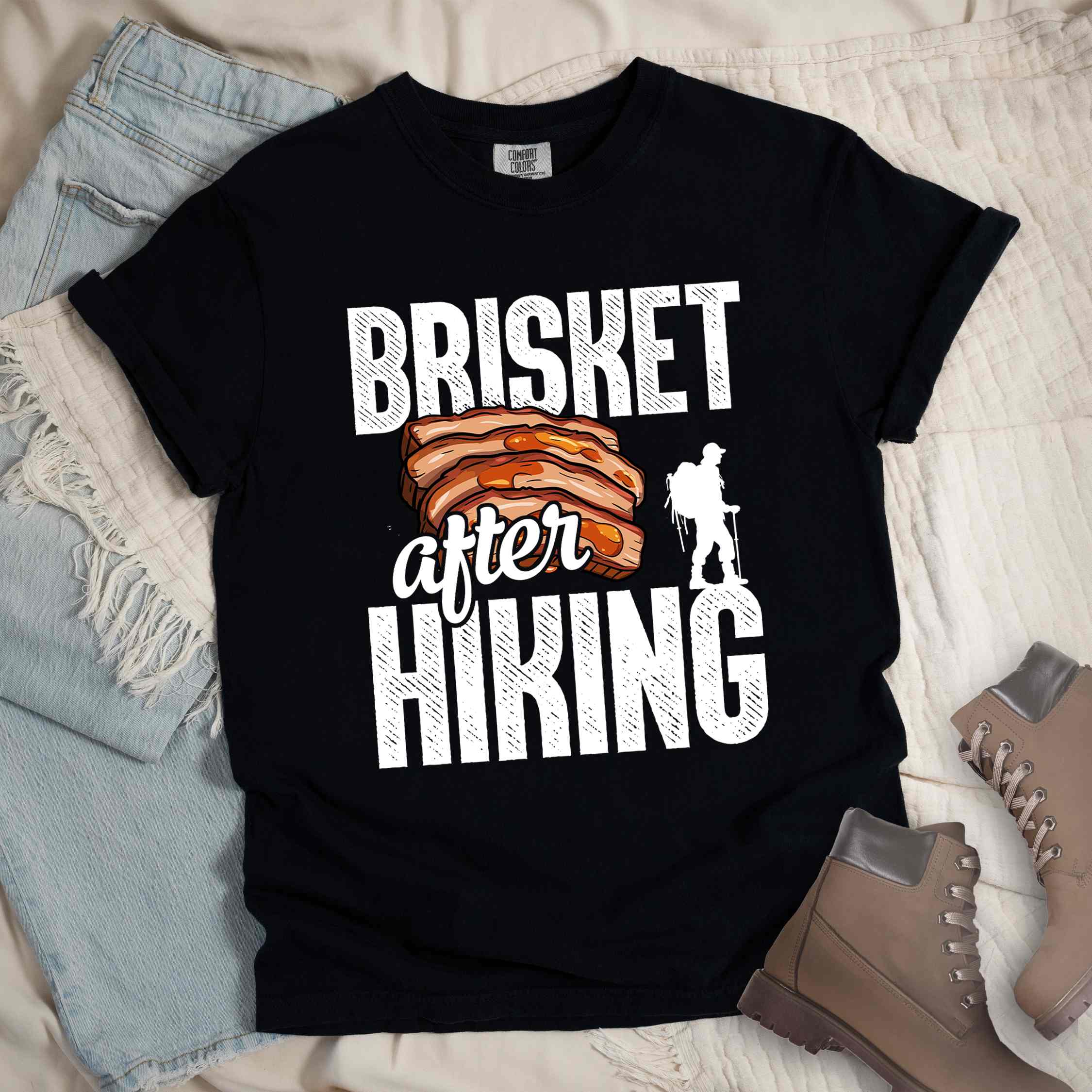 Black "Brisket after hiking" colored vintage tee with bold typography, birds, mountains, illustrated bbq beef brisket, and backpacker for bbq lovers.