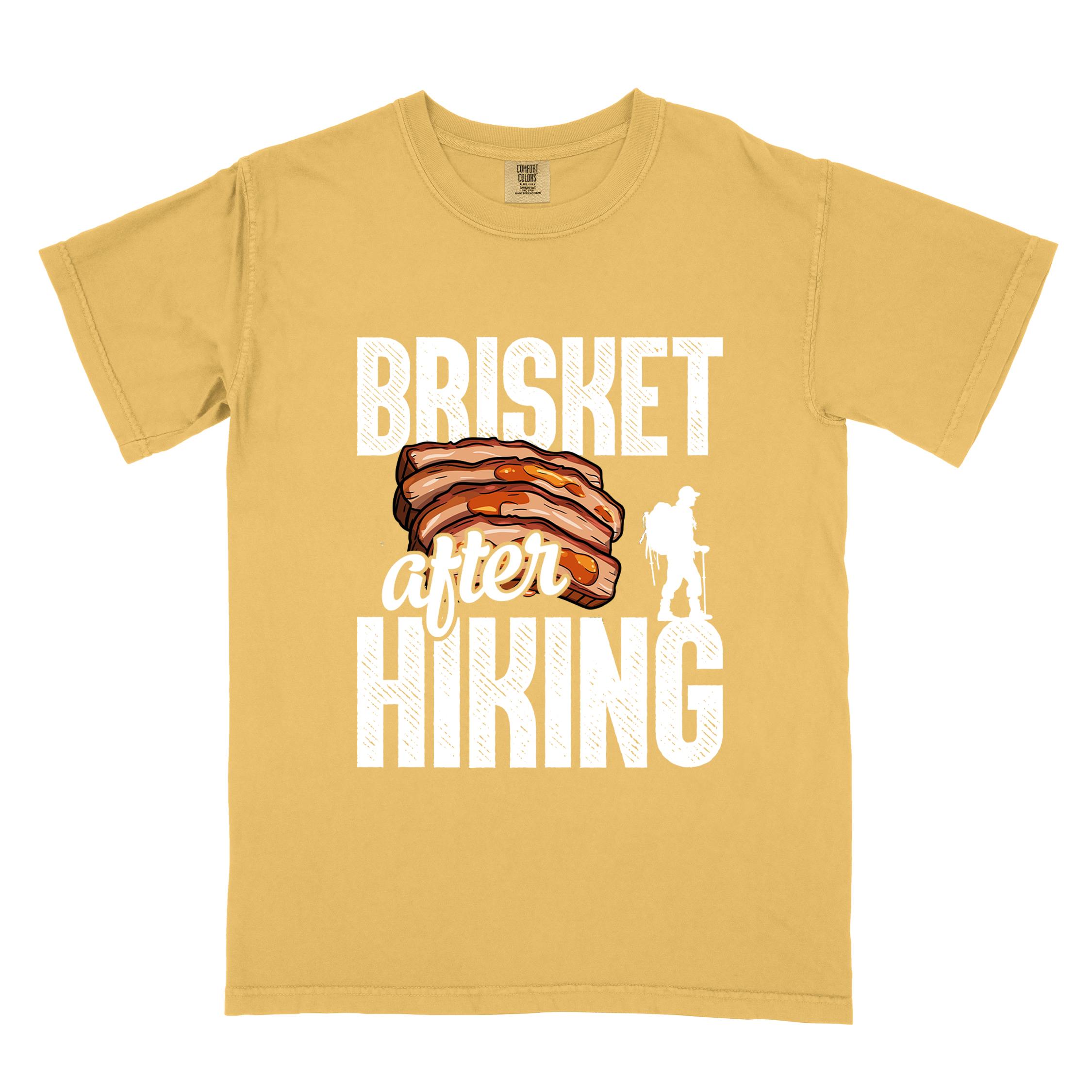 Mustard "Brisket after hiking" colored vintage tee with bold typography, birds, mountains, illustrated bbq beef brisket, and backpacker for bbq lovers.