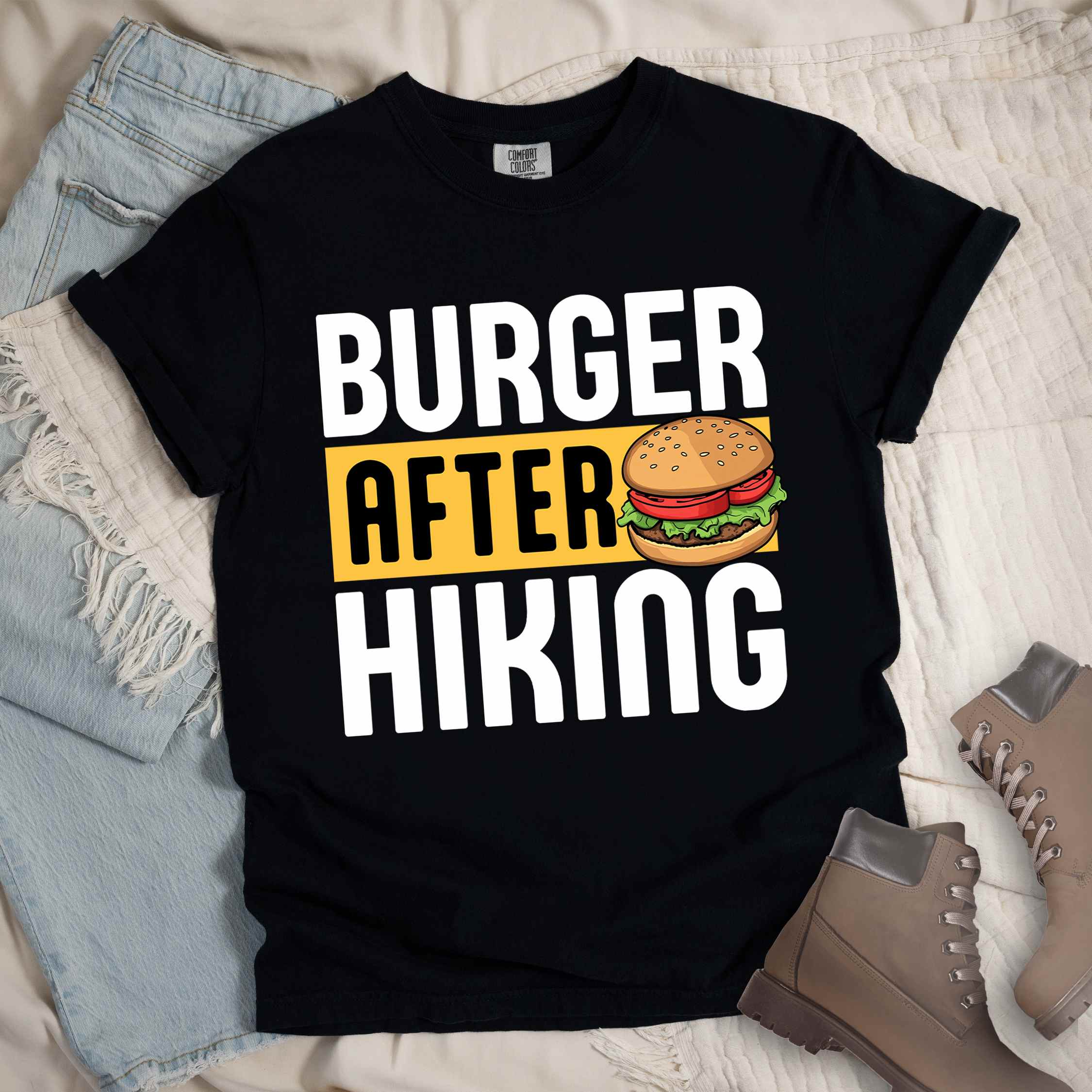 Black "Burger after Hiking" colored vintage tee with bold typography, birds, mountains, illustrated juicy hamburger, and backpacker for burger enthusiasts.
