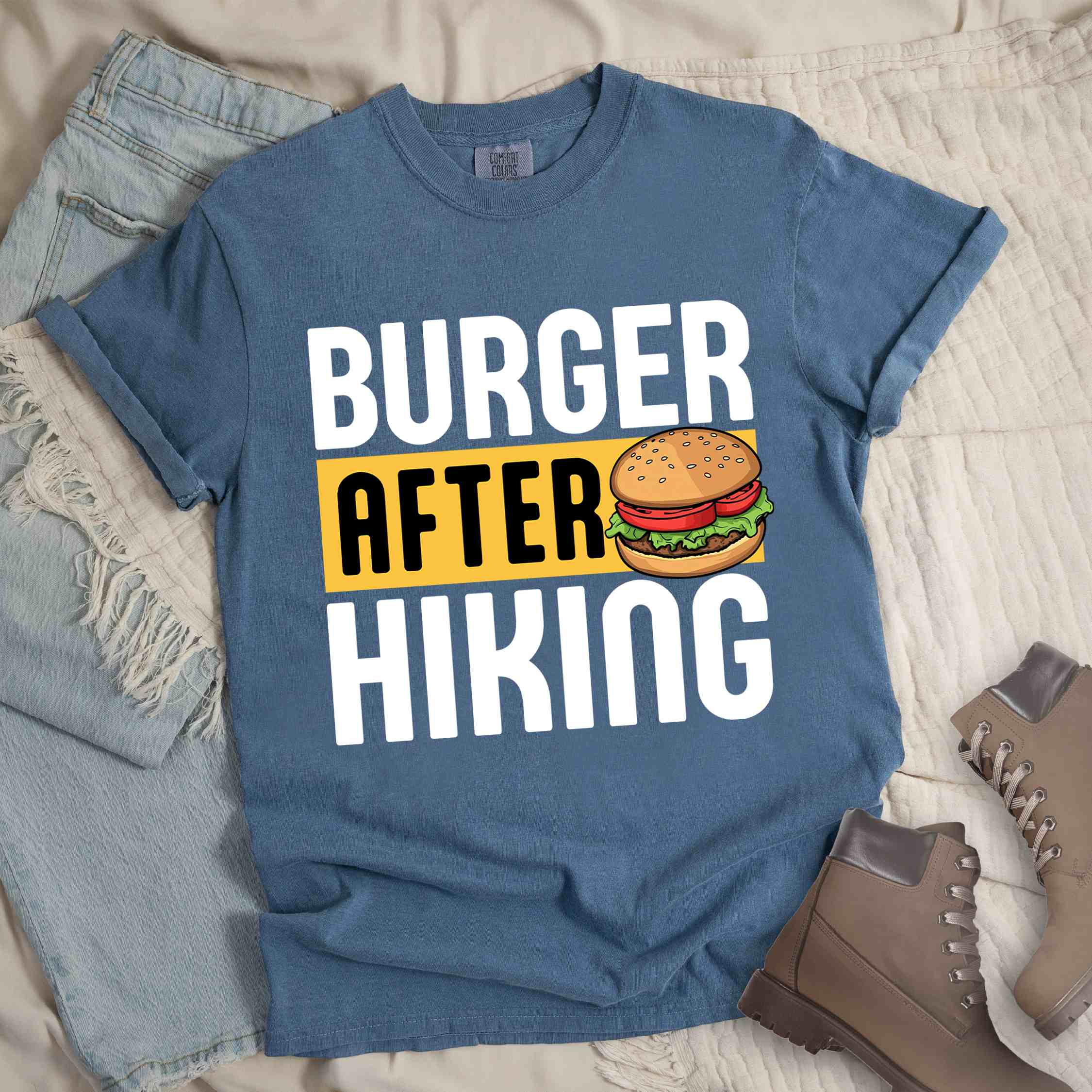 Blue jean "Burger after Hiking" colored vintage tee with bold typography, birds, mountains, illustrated juicy hamburger, and backpacker for burger enthusiasts.