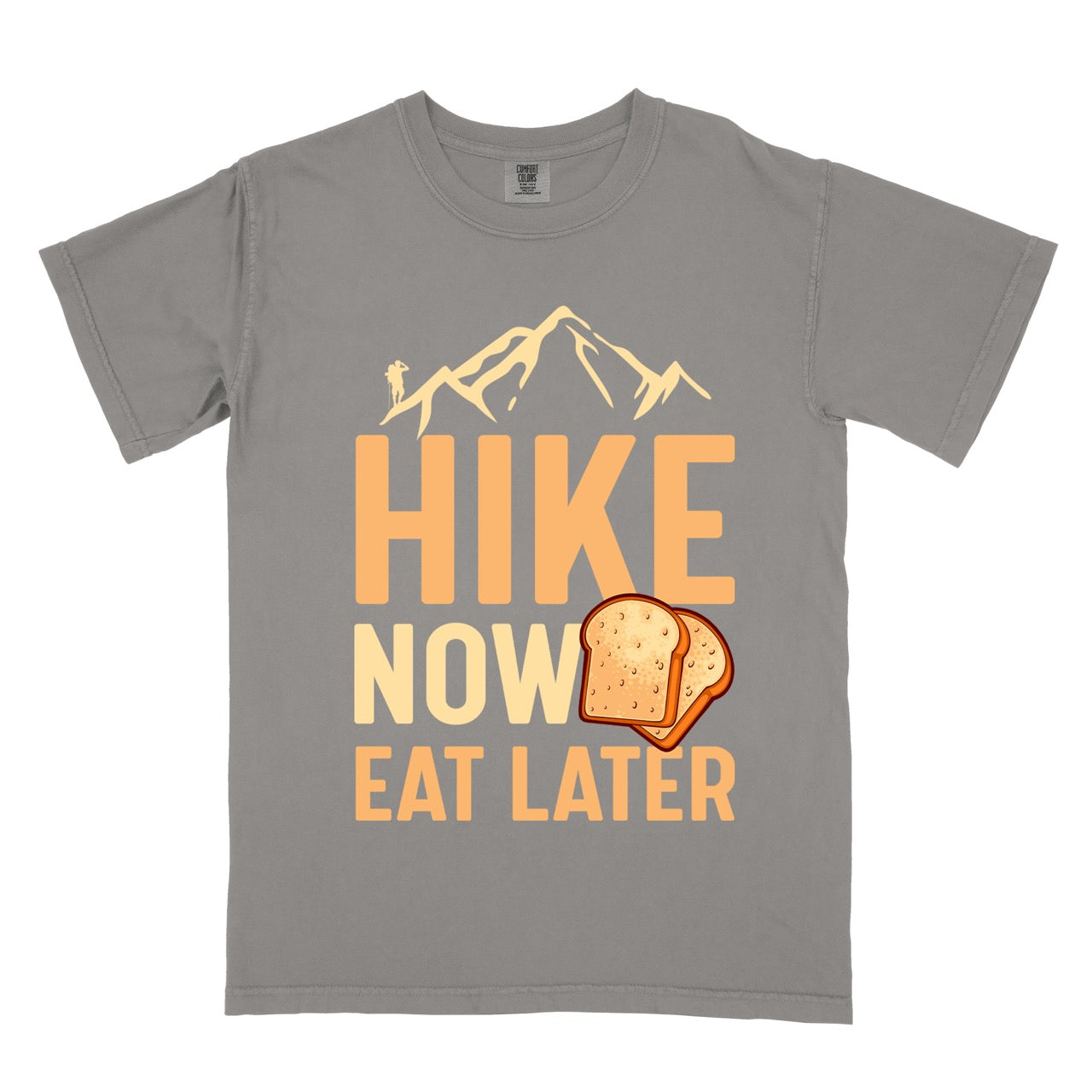 Gray Food motivation vintage tee Hike Now Eat Later with mountain peak range character silhouette bold typography and illustrated toast slices on Comfort Colors shirt for delayed gratification adventure enthusiasts, food lovers and hikers.
