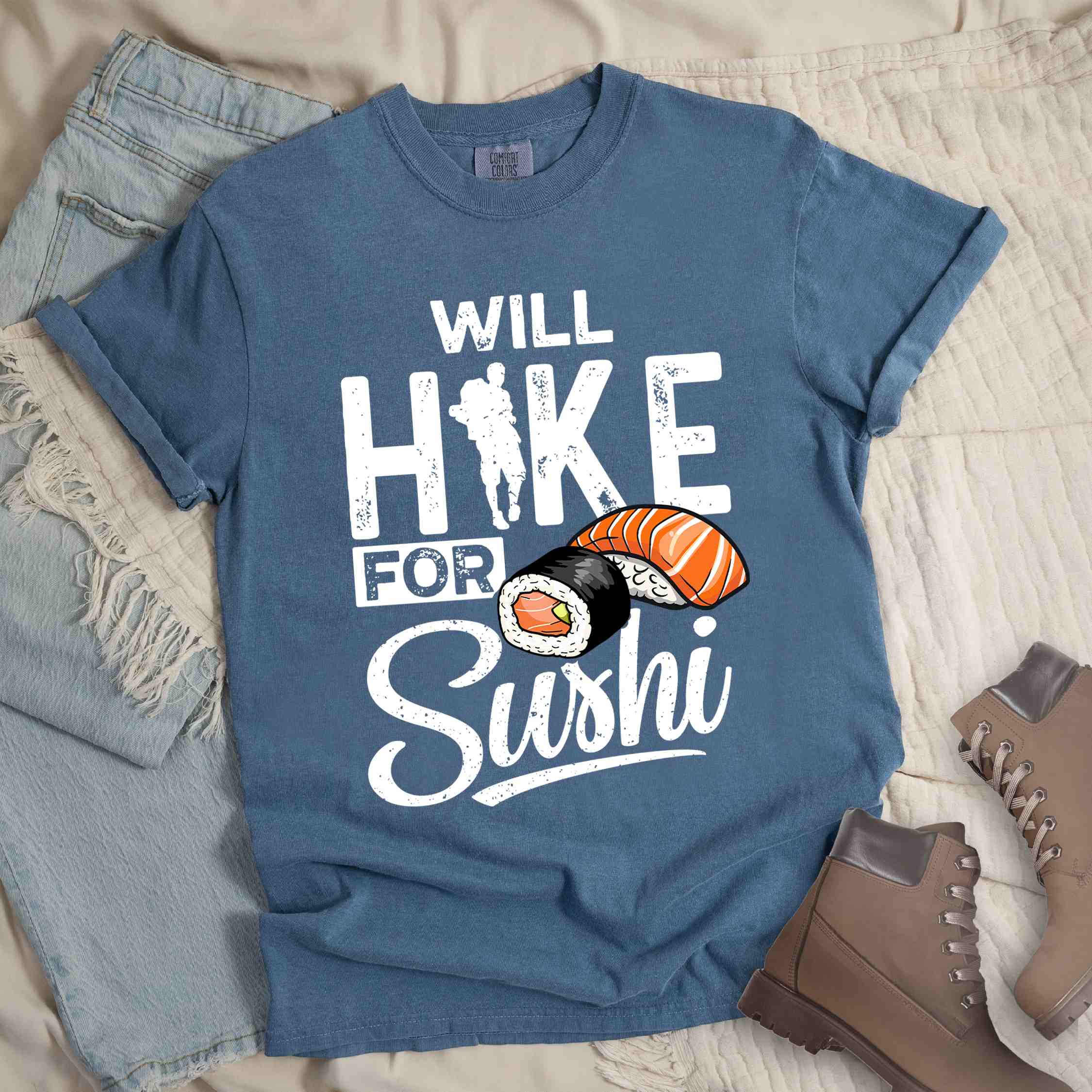Blue jean "Will hike for sushi" colored vintage tee with bold typography, birds, mountains, illustrated sushi platter, and backpacker for sushi lovers.