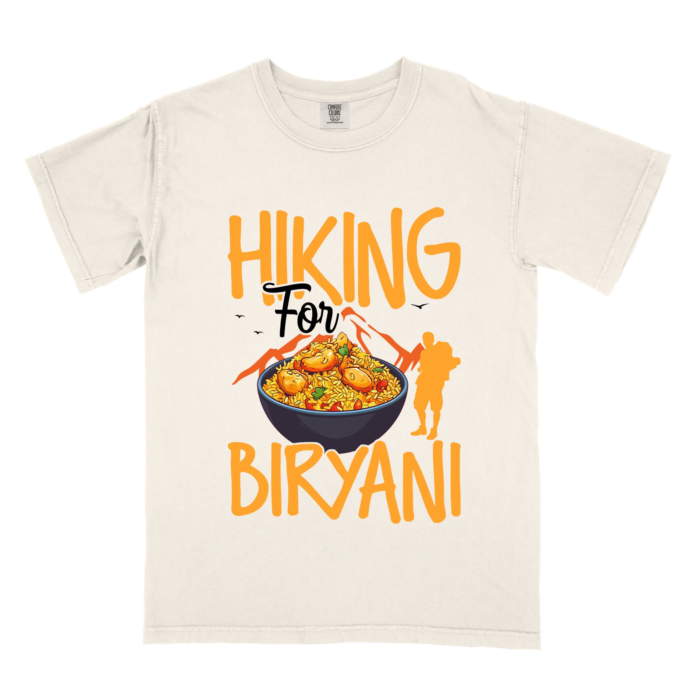 Ivory "Hiking for Biryani" colored vintage tee with bold typography, birds, mountains, illustrated bowl of biryani rice, and backpacker for rice lovers.