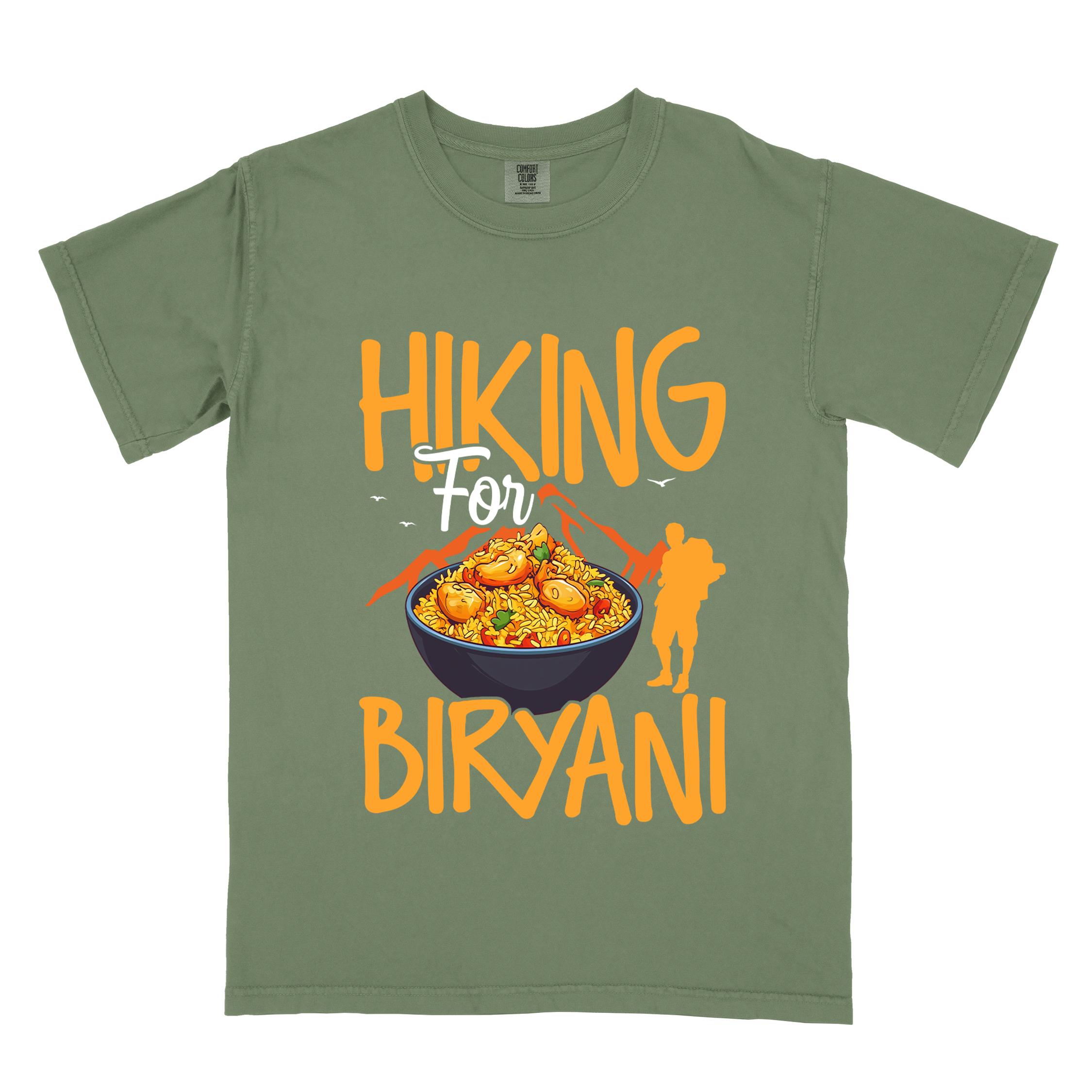 Moss "Hiking for Biryani" colored vintage tee with bold typography, birds, mountains, illustrated bowl of biryani rice, and backpacker for rice lovers.
