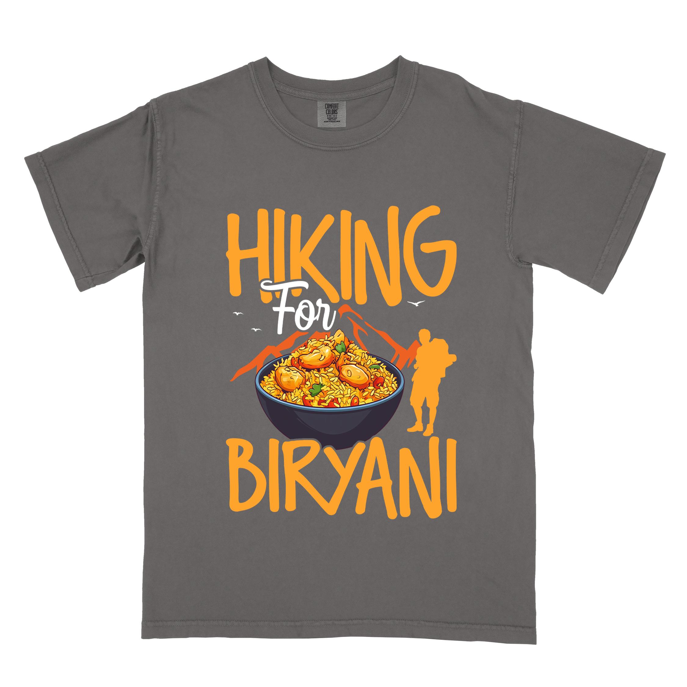 Pepper "Hiking for Biryani" colored vintage tee with bold typography, birds, mountains, illustrated bowl of biryani rice, and backpacker for rice lovers.