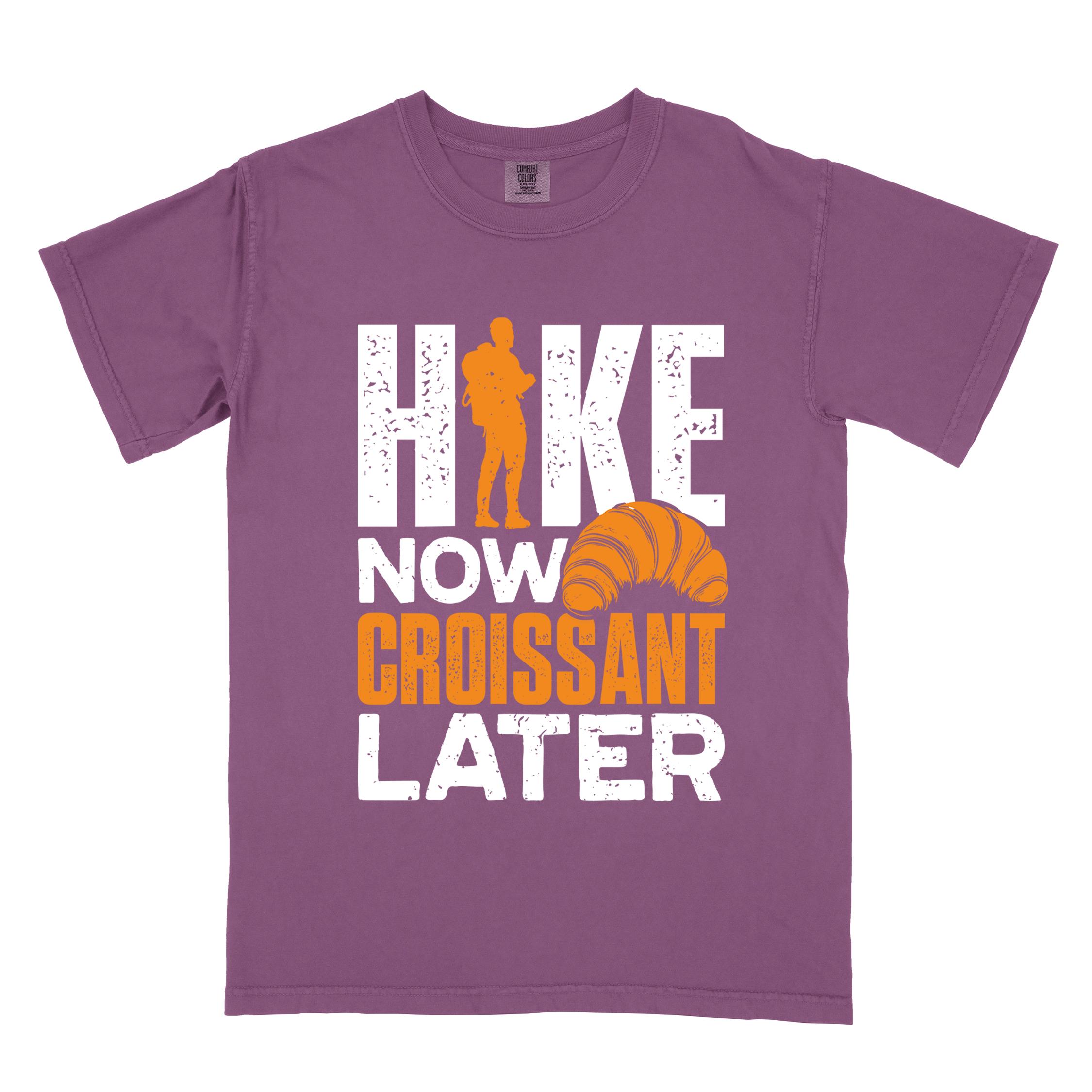Berry "Hike now croissant later" colored vintage tee with bold typography, birds, mountains, illustrated baked croissant, and backpacker for pastry enthusiasts.