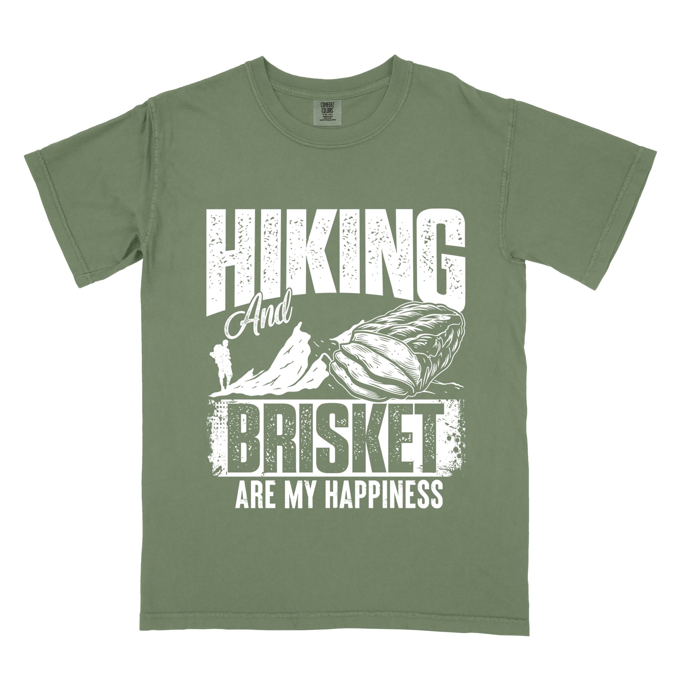 Moss "hiking and brisket are my happiness" colored vintage tee with bold typography, birds, mountains, illustrated bbq beef brisket, and backpacker for bbq lovers.