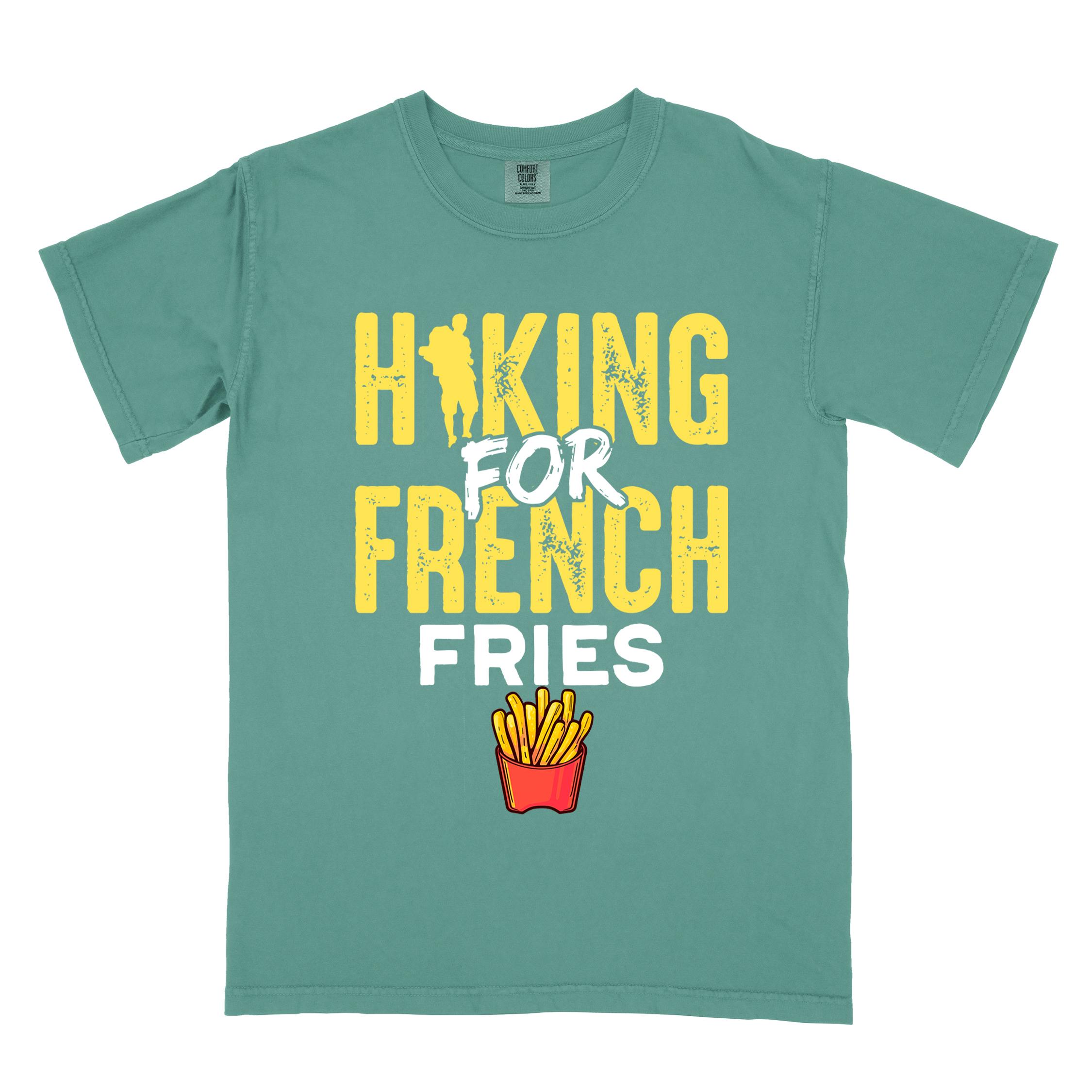 Light green "Hiking for french fries" colored vintage tee with bold typography, mountains, illustrated fries, and backpacker for comfort food enthusiasts.