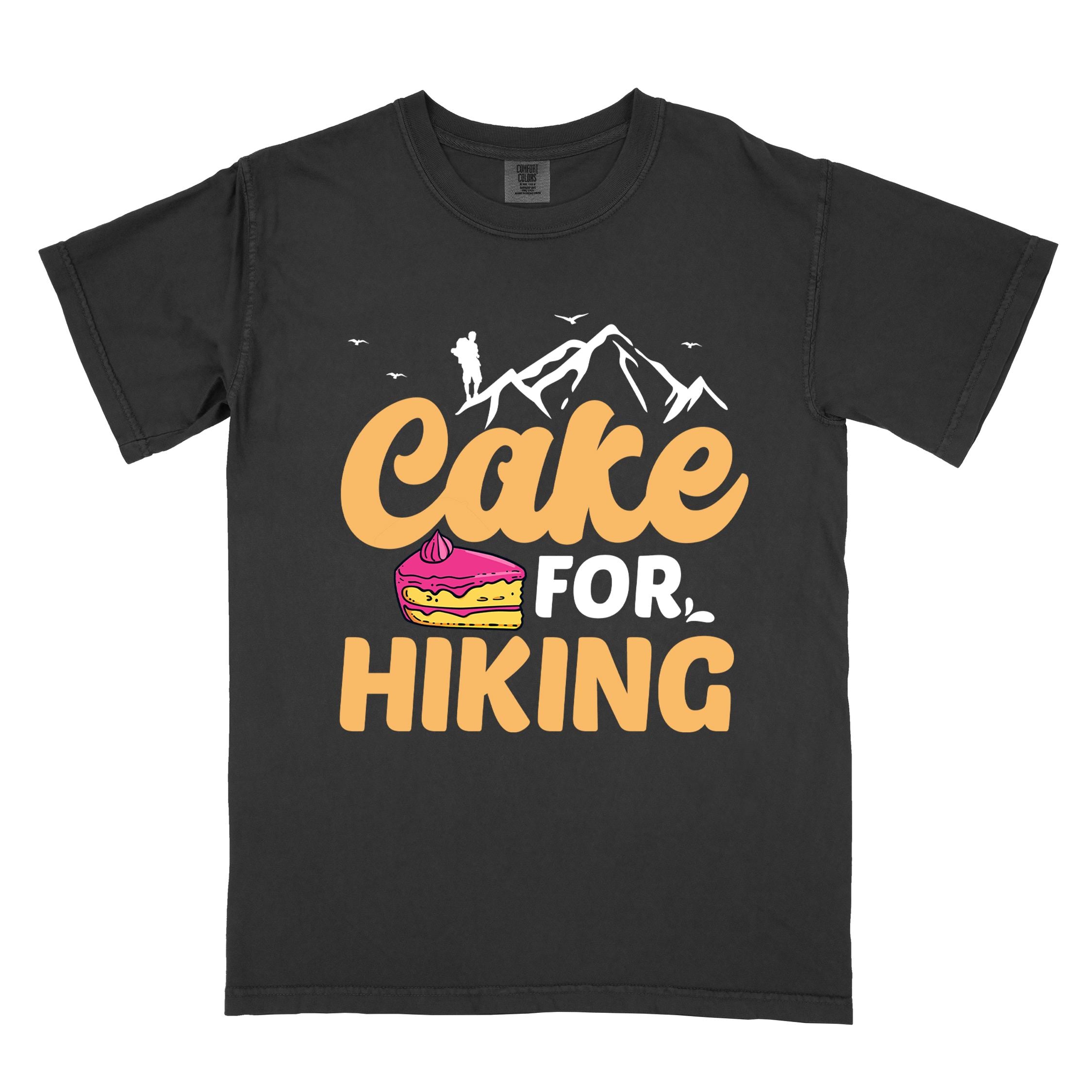 Black "Cake for Hiking" colored vintage tee with bold typography, mountains, illustrated a slice of cake, and backpackers with a sweet tooth.