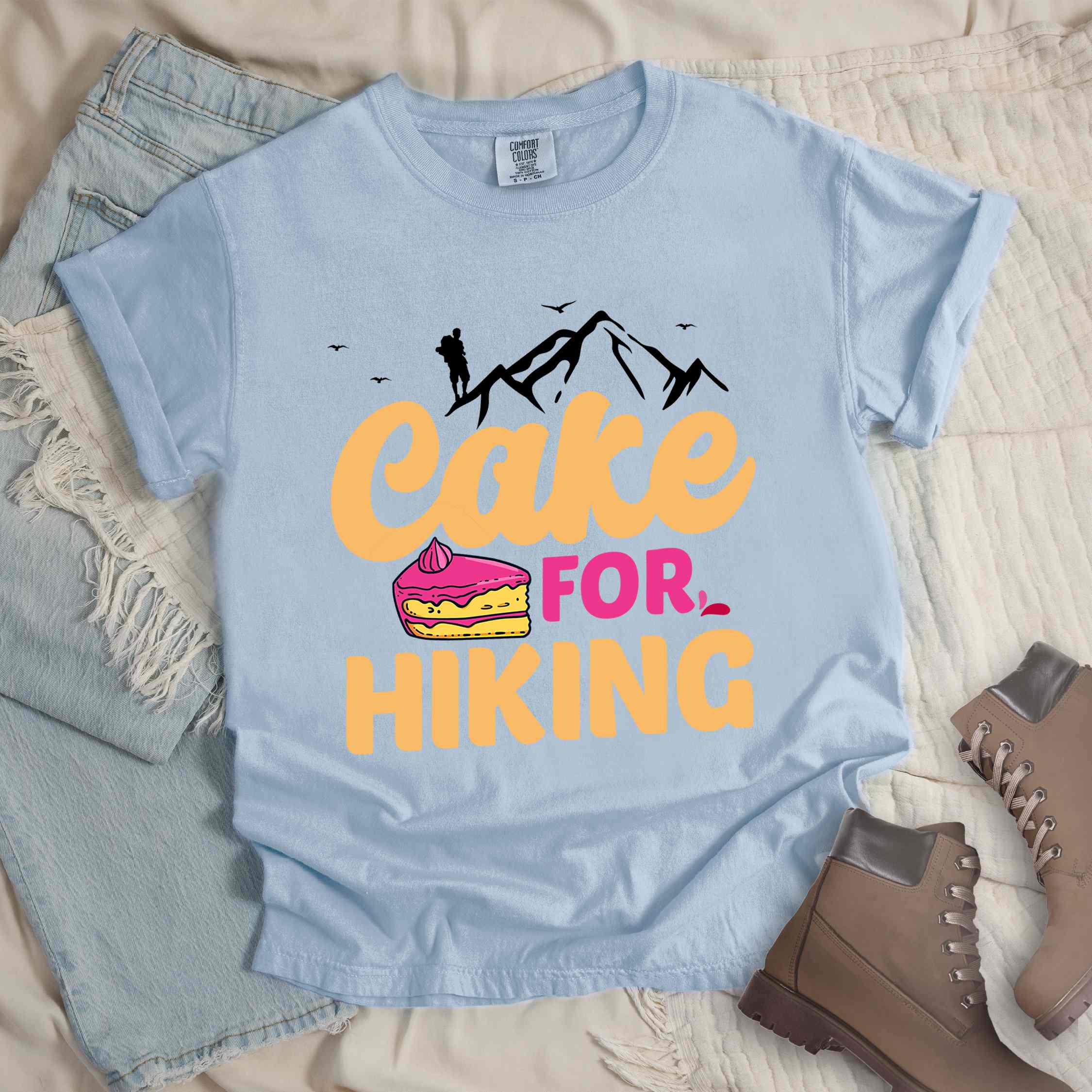 Chambray "Cake for Hiking" colored vintage tee with bold typography, mountains, illustrated a slice of cake, and backpackers with a sweet tooth.