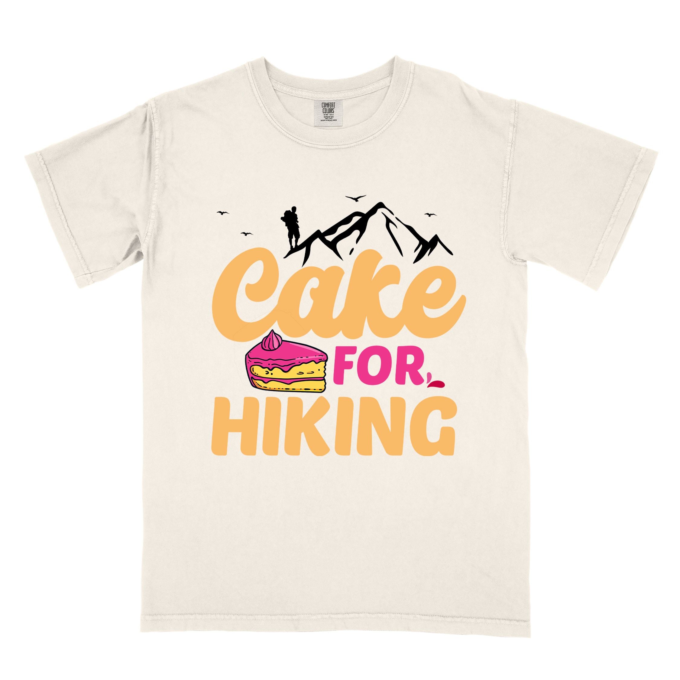 Ivory "Cake for Hiking" colored vintage tee with bold typography, mountains, illustrated a slice of cake, and backpackers with a sweet tooth.