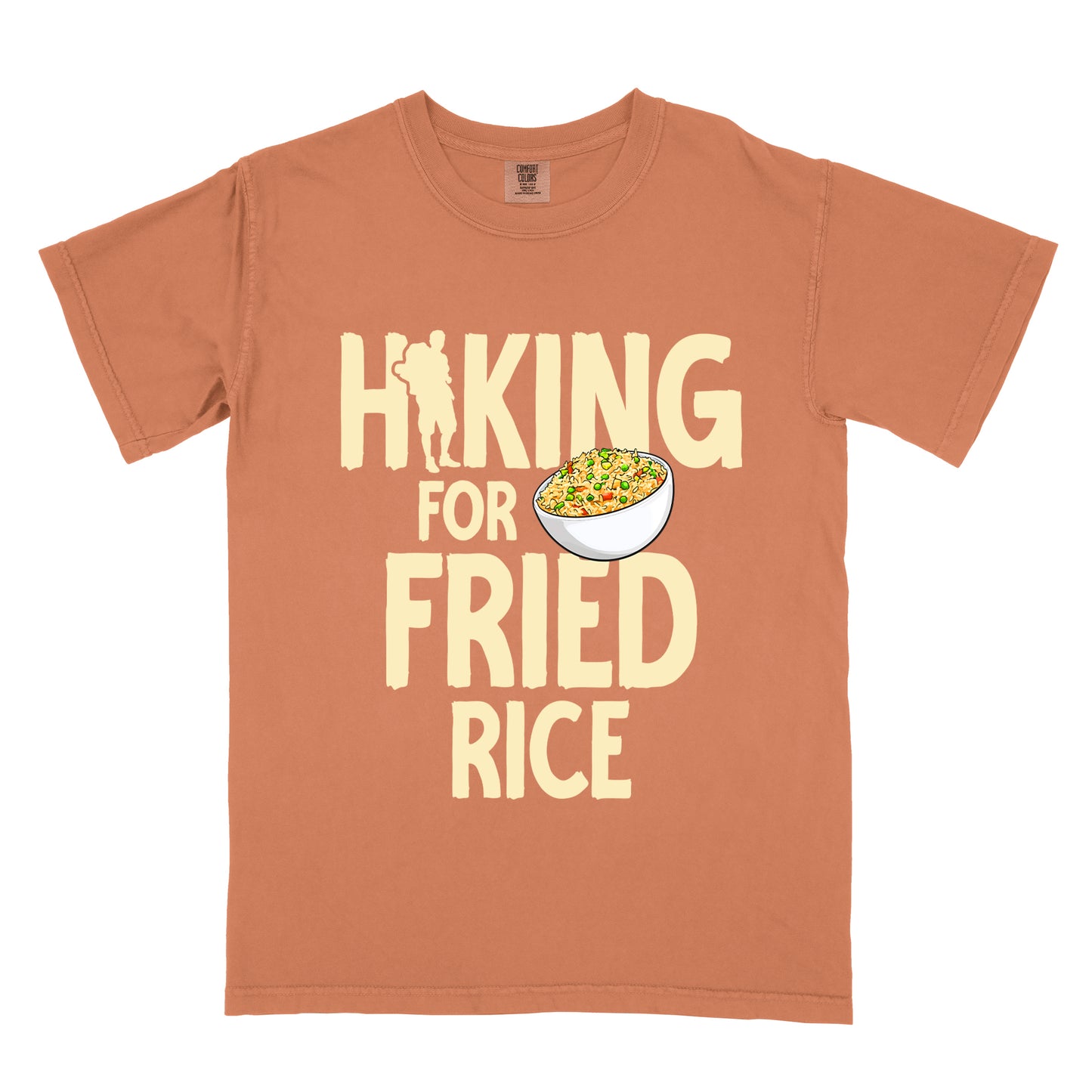 Yam (Brown) t-shirt with pale yellow text reading "HIKING FOR FRIED RICE". "HIKING" appears at the top with a hiker silhouette integrated into the letter "I", "FOR" in smaller text in the middle, and "FRIED RICE" in large letters at the bottom. Features an illustration of a white bowl filled with colorful fried rice with vegetables next to "FOR" and above "FRIED".