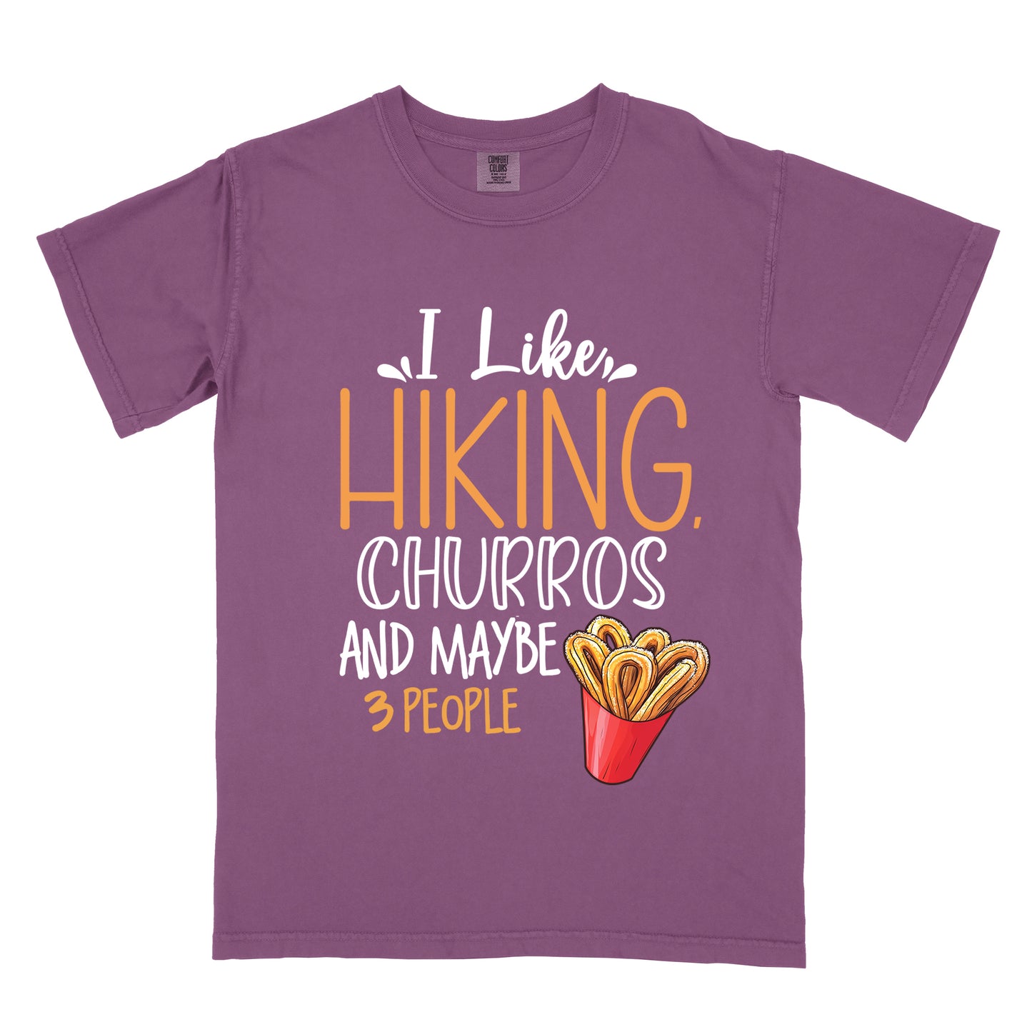 Berry (Dark Violet) t-shirt with white and orange text reading "I Like HIKING, CHURROS AND MAYBE 3 PEOPLE". "I Like" appears in white script at the top, "HIKING," in large orange letters, "CHURROS" in white outlined letters, "AND MAYBE" in white, and "3 PEOPLE" in small orange text at the bottom. Features an illustration of churros in a red container on the right side.