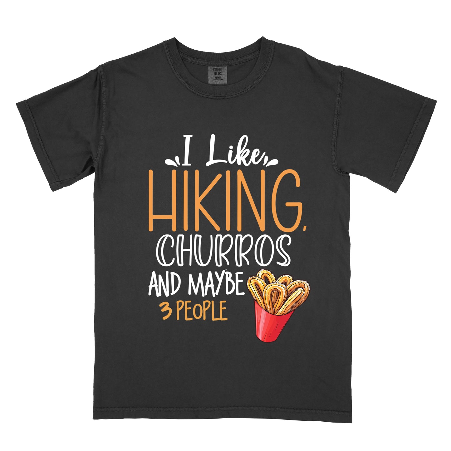 Black t-shirt with white and orange text reading "I Like HIKING, CHURROS AND MAYBE 3 PEOPLE". "I Like" appears in white script at the top, "HIKING," in large orange letters, "CHURROS" in white outlined letters, "AND MAYBE" in white, and "3 PEOPLE" in small orange text at the bottom. Features an illustration of churros in a red container on the right side.