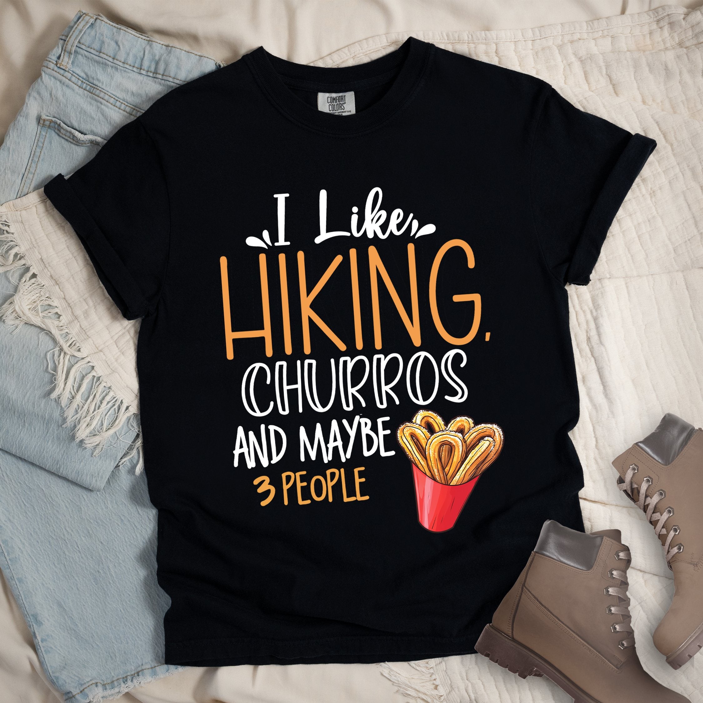 Black shirt with the phrase “I Like Hiking, Churros, And Maybe 3 People.” Includes a churros cup illustration.