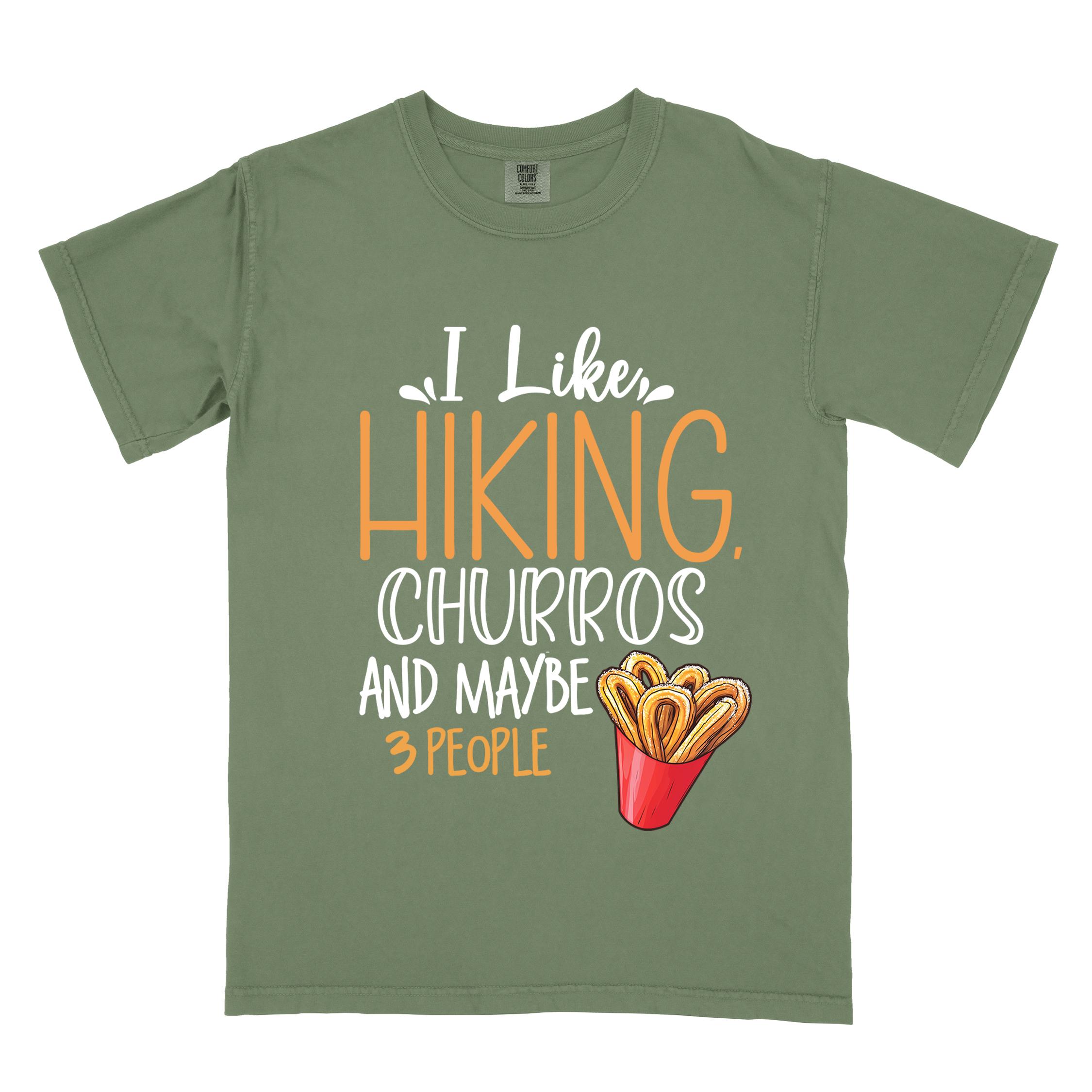 Moss "I like hiking, churros and maybe three people " colored vintage tee with bold typography, mountains, illustrated a serving of Churros, and backpackers with a sweet tooth.