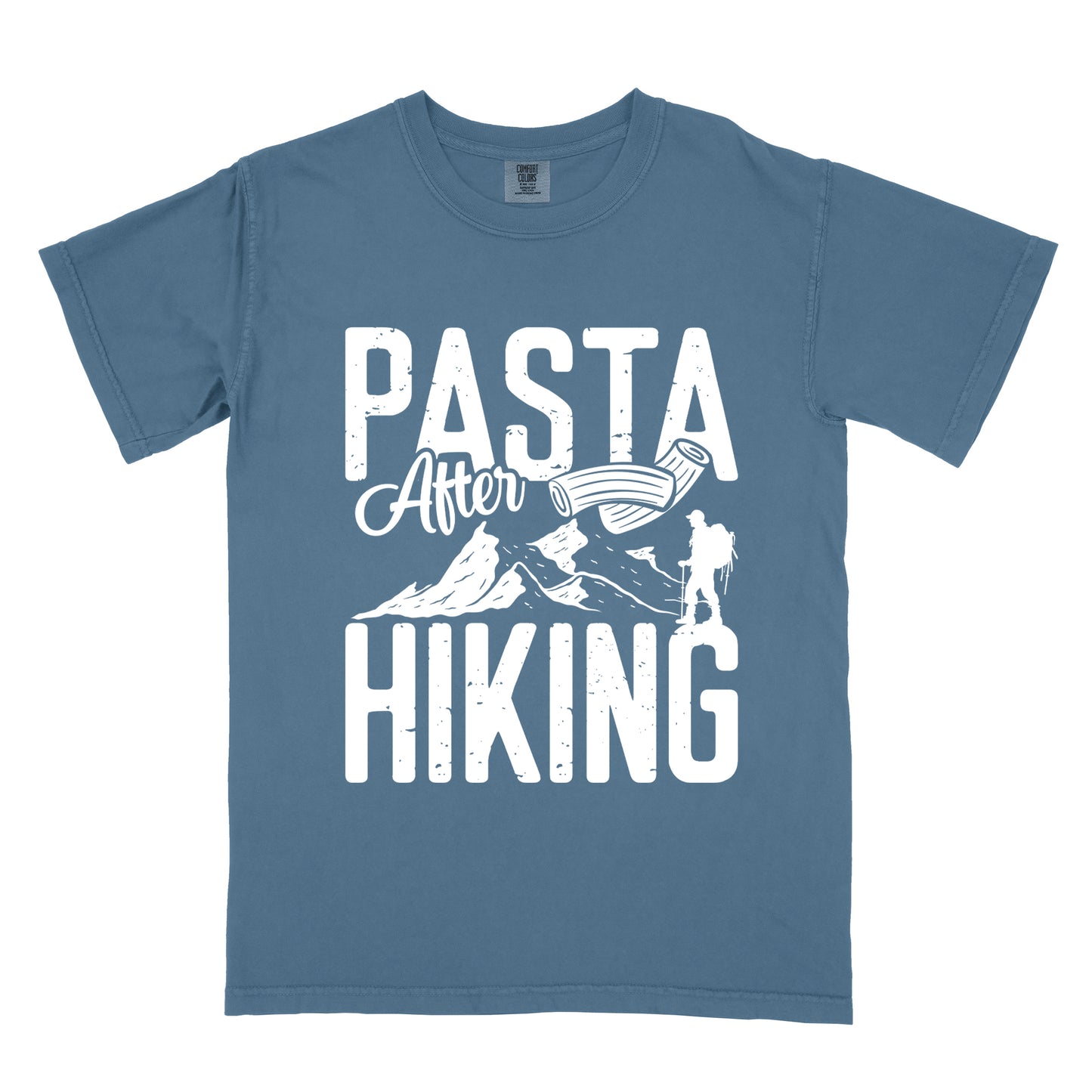 Blue Jean (Denim Blue) t-shirt with white distressed text reading "PASTA After HIKING". "PASTA" appears in large block letters at the top, "After" in script in the middle, and "HIKING" in large block letters at the bottom. Features white mountain silhouettes in the center, a white hiker silhouette on the right side, and an illustration of penne pasta above the mountains.