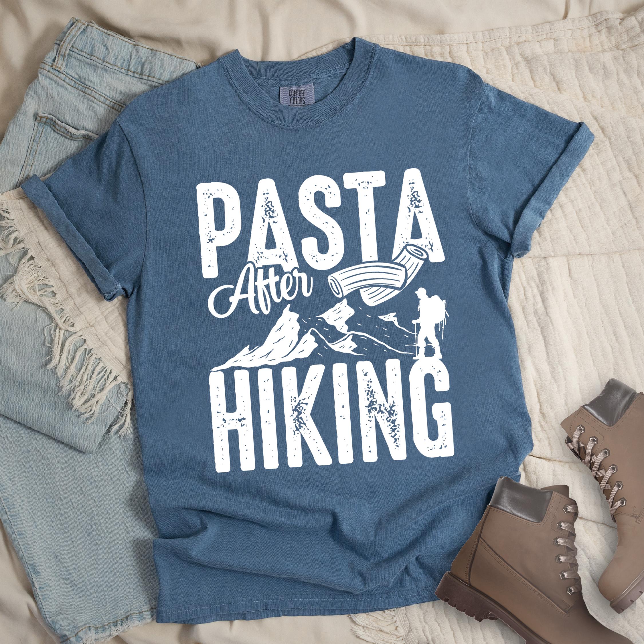 Dark blue shirt with the phrase “Pasta After Hiking.” Includes a hiker silhouette, mountain outline, and pasta noodle illustration.