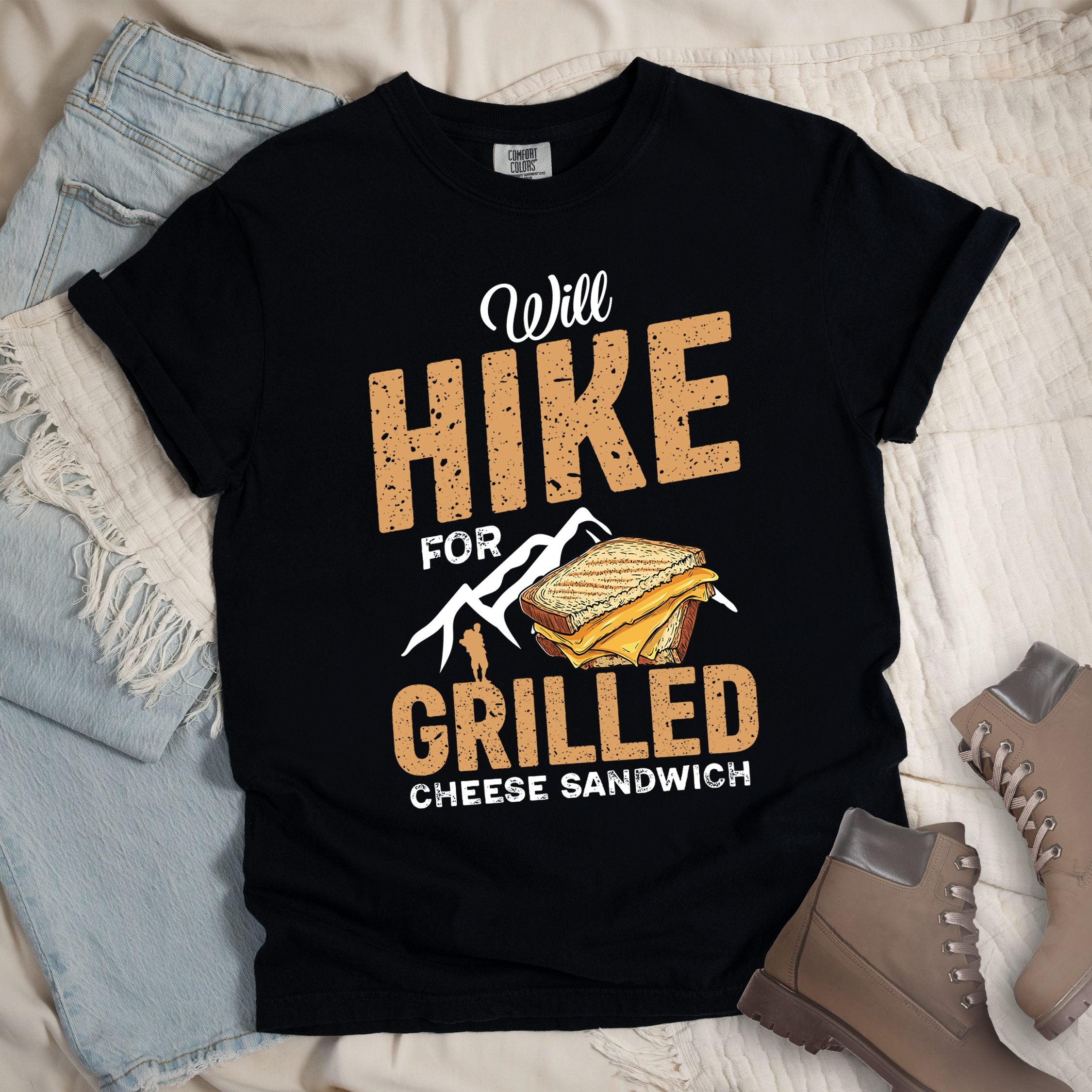 Black shirt with Hiking Design featuring the phrase “Will Hike for Grilled Cheese Sandwich” and an illustration of a grilled cheese sandwich below a mountain outline.