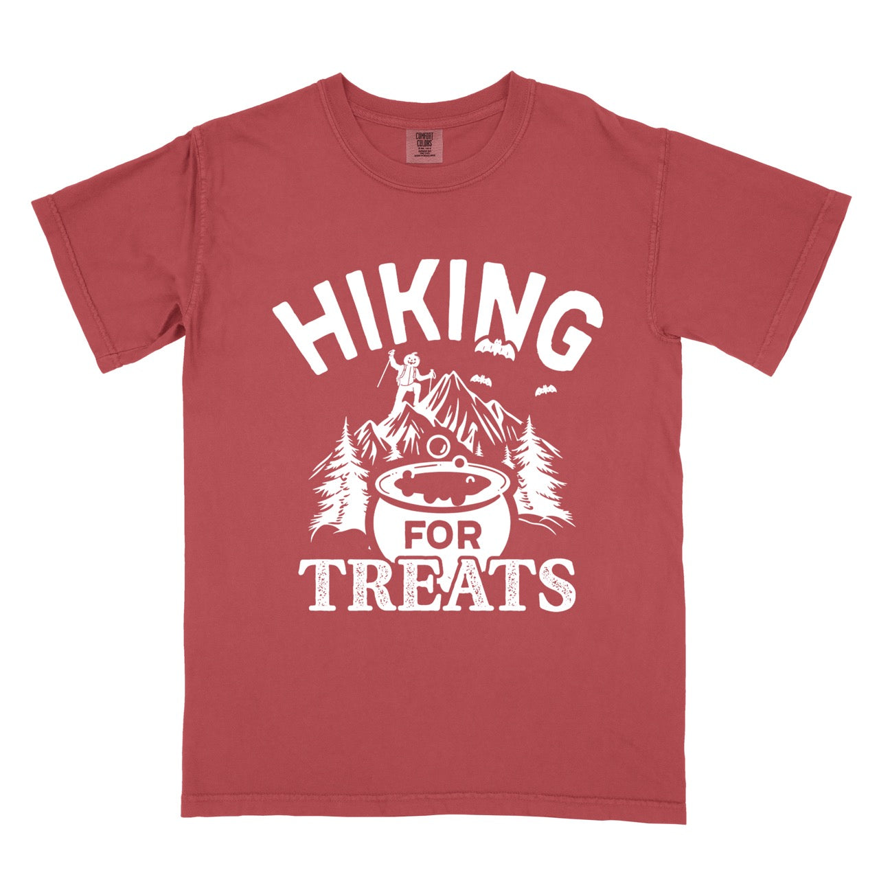 Crimson Halloween vintage tee Hiking for Treats featuring curved typography bubbling cauldron with candy mountain landscape with character on peak pine trees and flying bats on Comfort Colors shirt for spooky season celebrations for hikers, foodies and adventurers.
