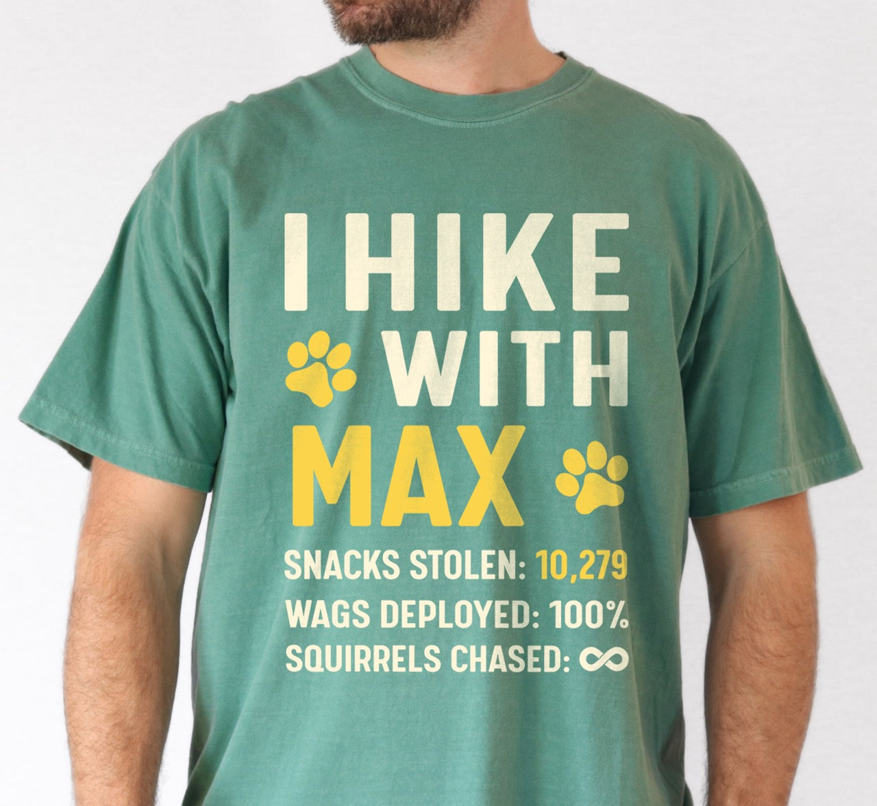 Man wearing Personalized dog hiking shirt I Hike with custom pet name  of Max featuring paw print graphic, funny adventure statistics including snacks stolen  of 10, 279, wags deployed and squirrels chased on Comfort Colors tee for outdoor pet lovers