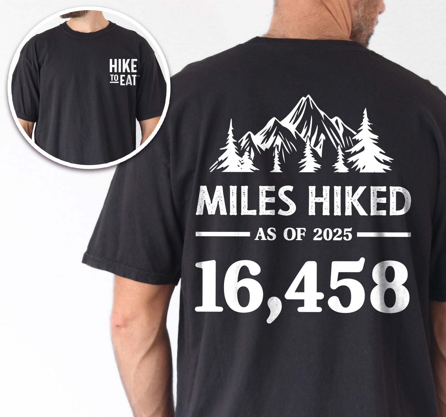 Black Hike to Eat t-shirt front and back view showing small white chest detail and large back design featuring 'Milestone Tracker Personalized' with mountain and pine tree silhouettes, 'Miles Hiked as of 2025' text and customizable numbers field, displaying example number 16,458.