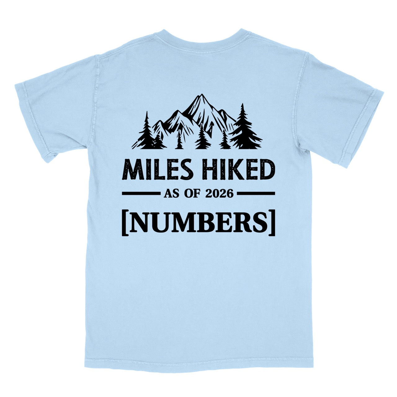 Chambray (light blue) t-shirt with Hike to Eat logo on front chest, back featuring MILES HIKED AS OF 2026 text with personalized number field, mountain and pine tree silhouettes, customizable achievement tracker design - perfect for hikers. 