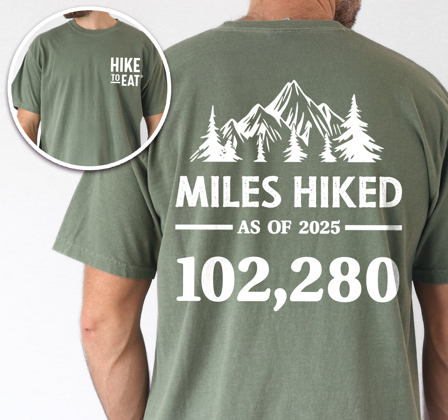 Moss (Dark Green) Hike to Eat t-shirt front and back view showing small white chest detail and large back design featuring 'Milestone Tracker Personalized' with mountain and pine tree silhouettes, 'Miles Hiked as of 2025' text and customizable numbers field, displaying example number 102,280.