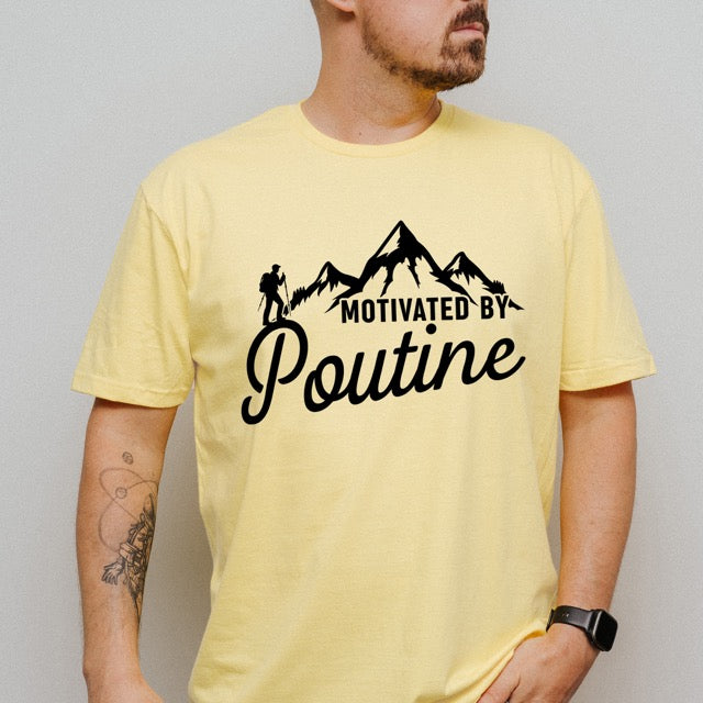 Man wearing Cornsilk (yellow) Motivated by Poutine statement tee with distressed typography, mountain peaks, and hiker silhouette for poutine lovers and canadian food lovers