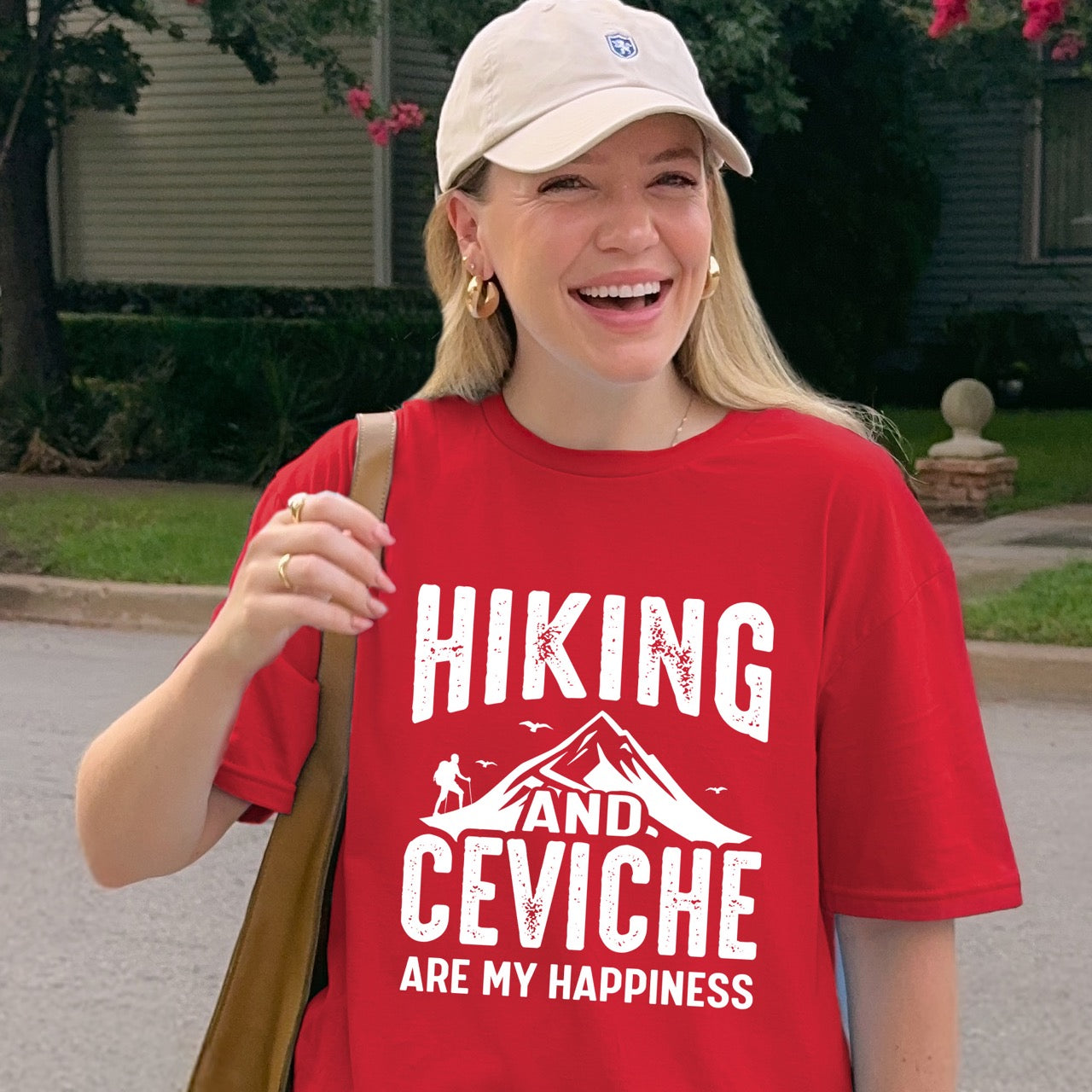 Woman wearing Red Hiking and Ceviche are my Happiness statement tee with distressed bold typography, mountain peaks, hiker silhouette, and flying birds for seafood-loving outdoor enthusiasts, foodies and hikers