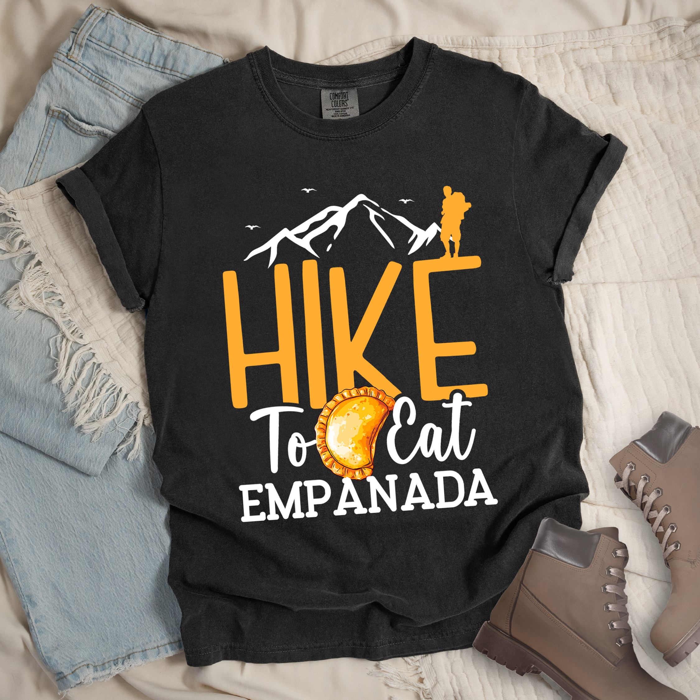 Dark grey shirt with Hiking Design featuring the phrase “Hike to Eat Empanada” and a hiker silhouette above a plate of empanada.