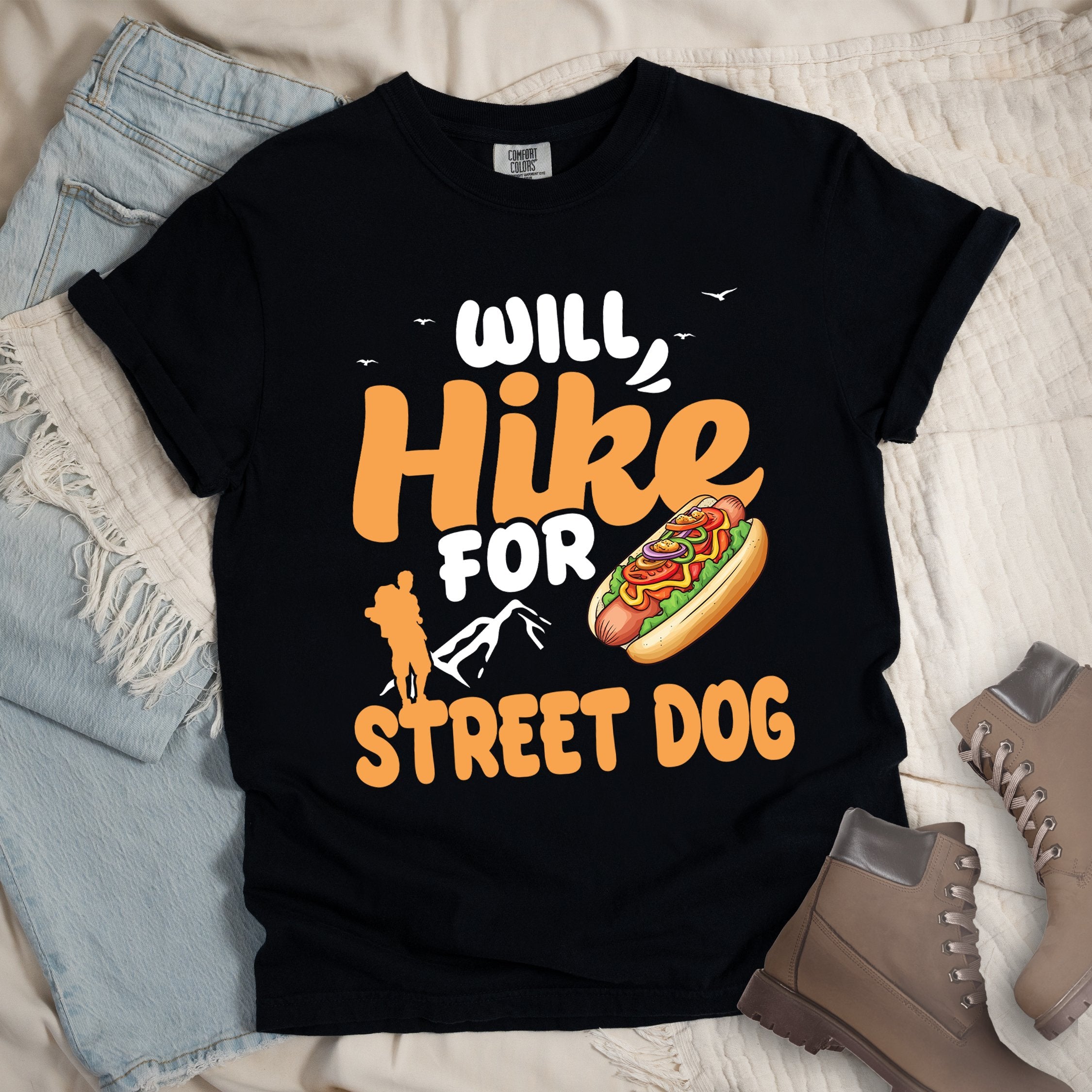 Black shirt with Hiking Design featuring the phrase “Will Hike for Street Dog” and an illustration of a hot dog with toppings.