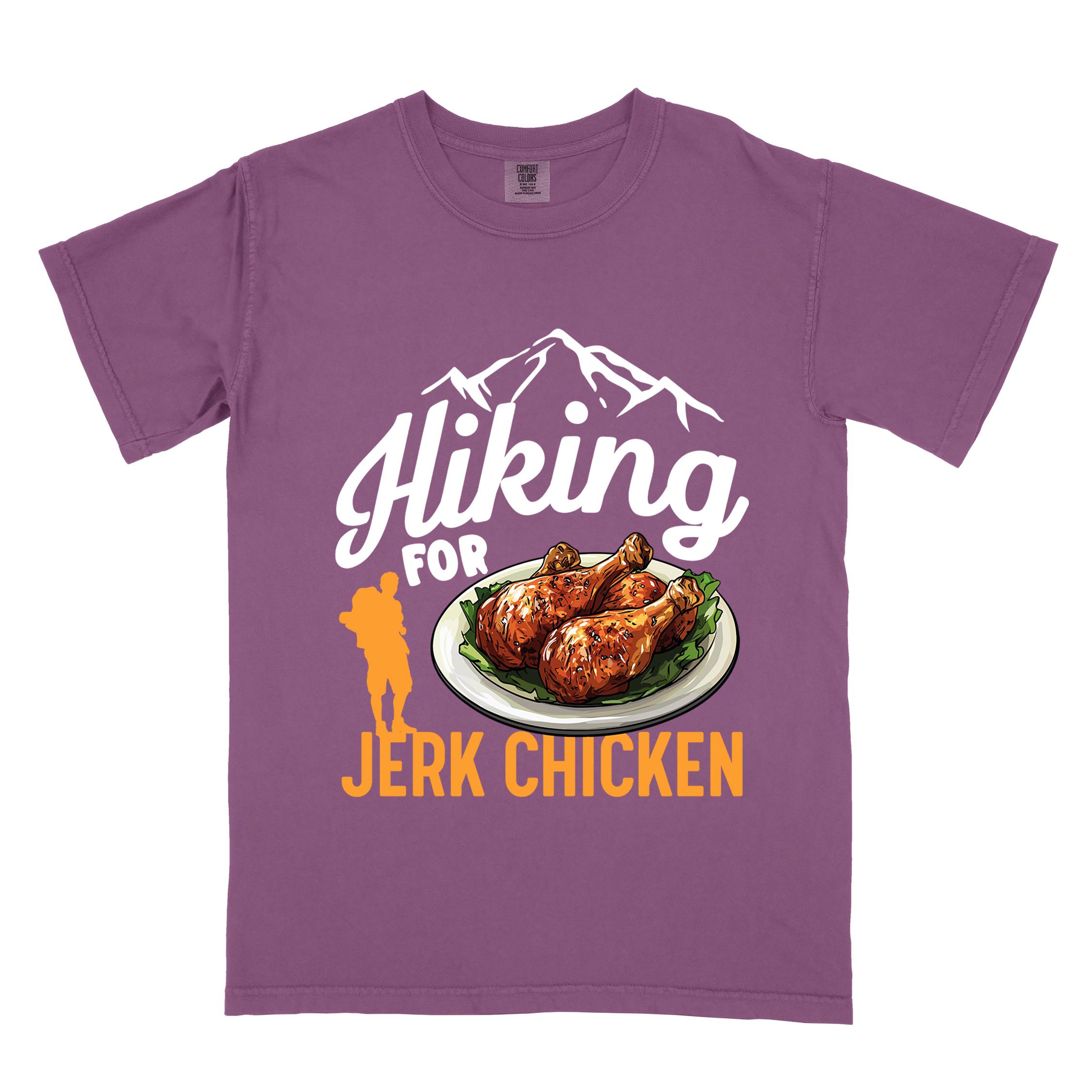 Berry "hiking for jerk chicken" colored vintage tee with bold typography, illustrated jerk chicken on a plate, mountains, birds, and backpackers for bbq chicken lovers.